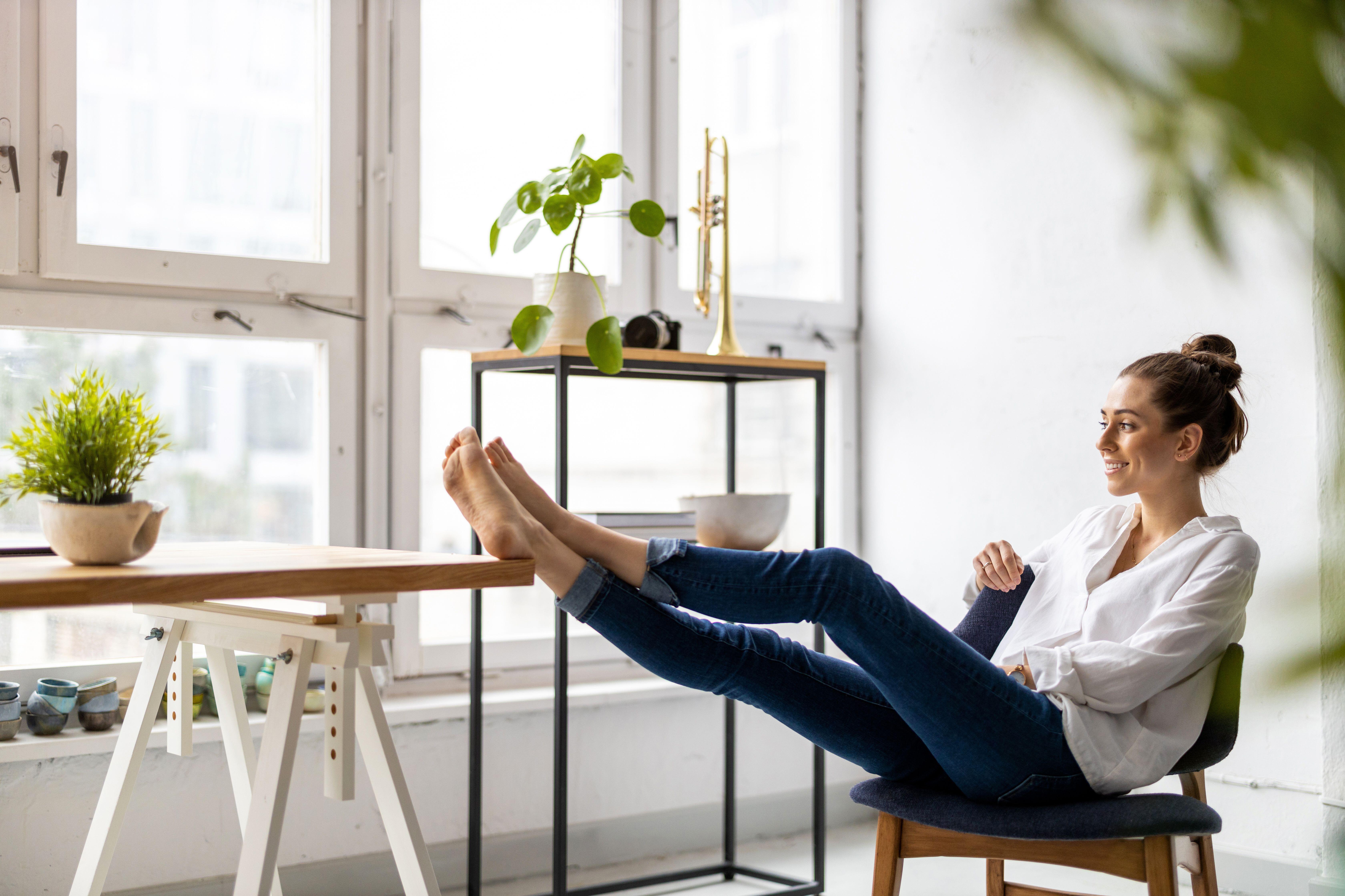 A woman looking happy with her feet up