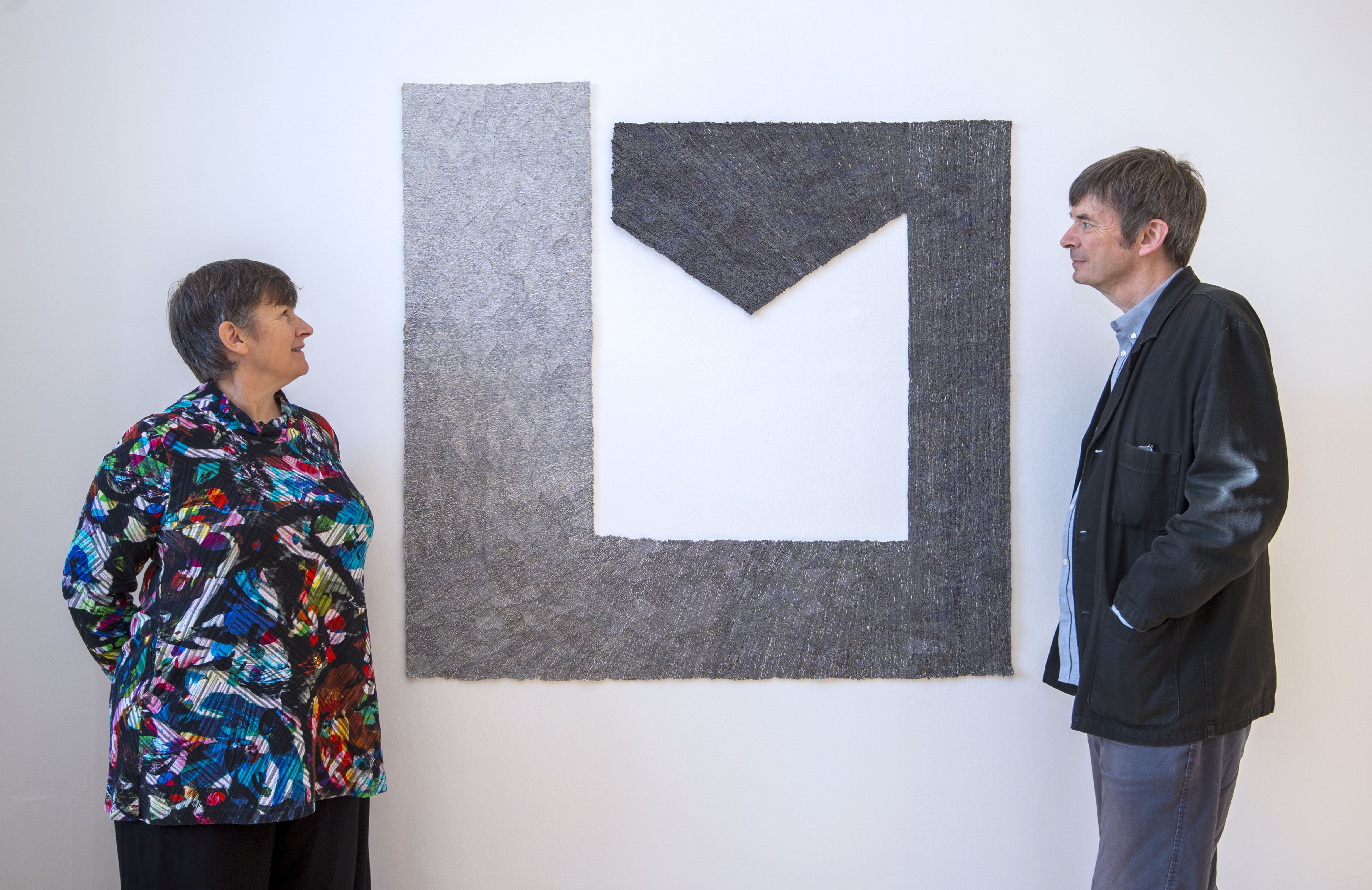 Miranda Harvey and Ian Rankin of the Cordis Prize with the 2021 winning tapestry by artist Louise Martin