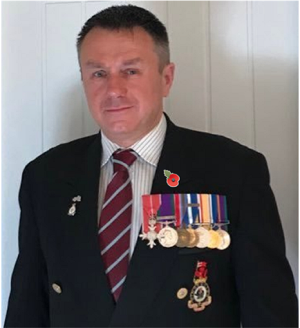 Mark Hill wearing his medals