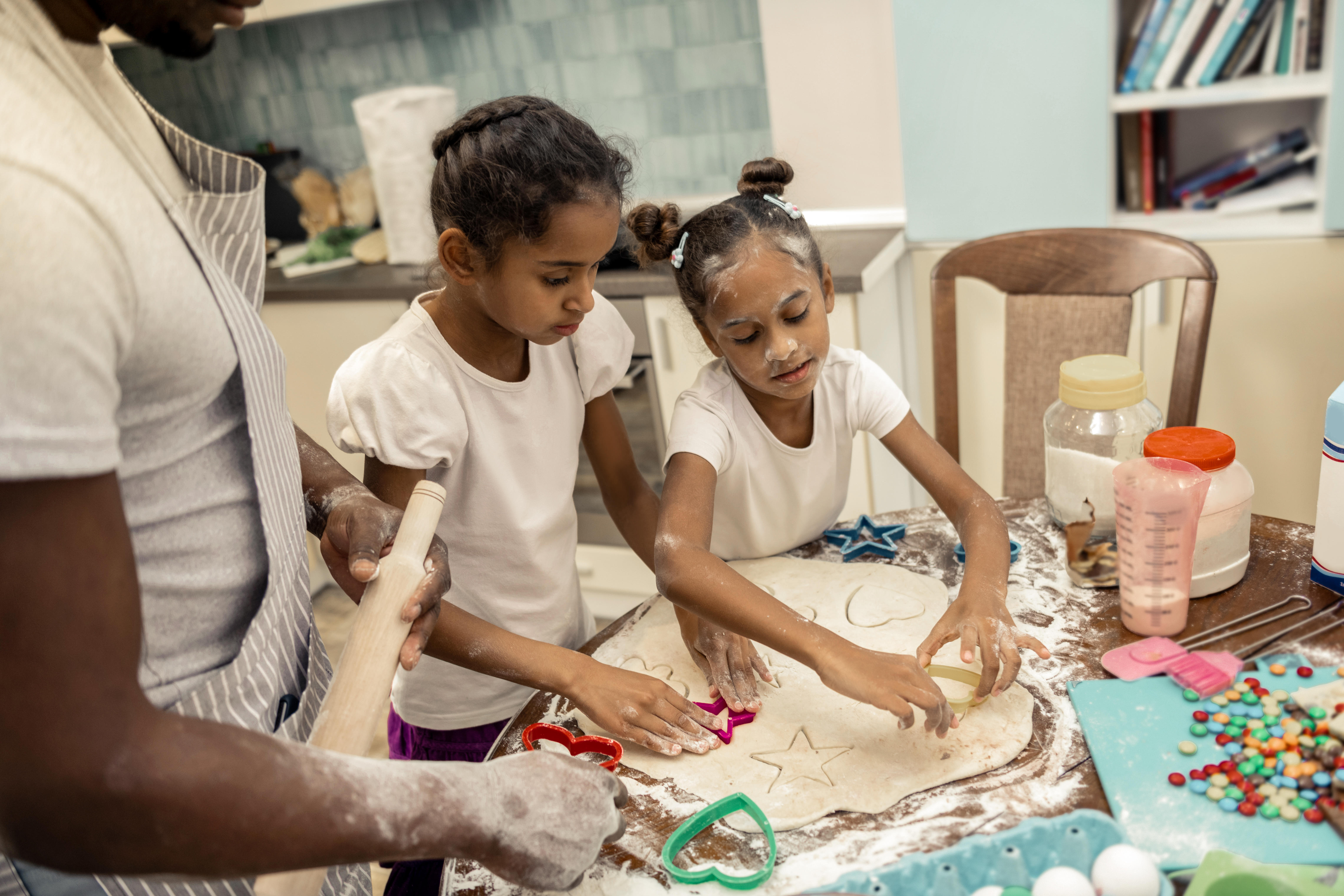 Kids baking cookies with their dad