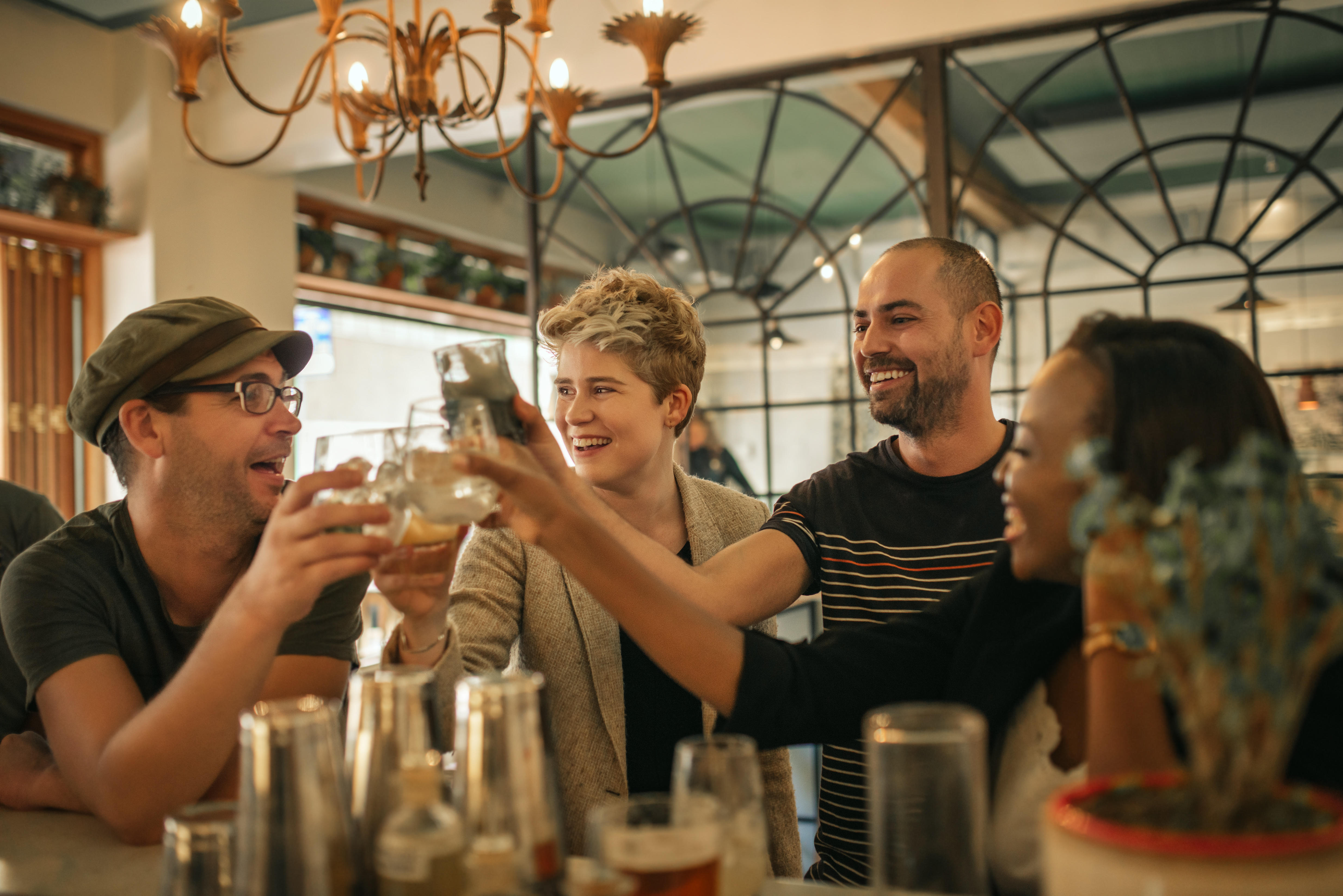 friends cheersing in a bar