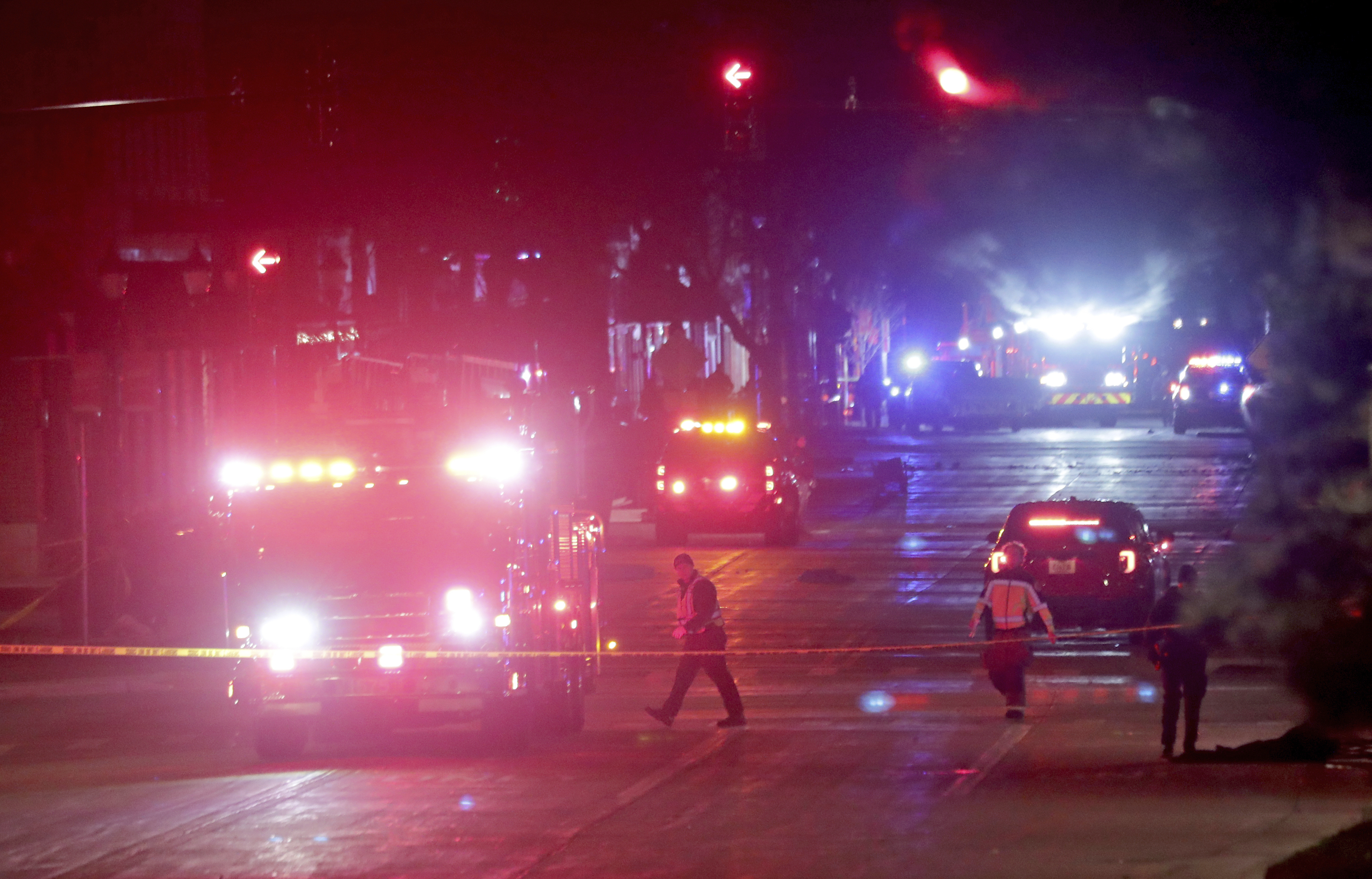 Police investigate at the scene of a crash involving multiple people and injuries at a holiday parade in Waukesha