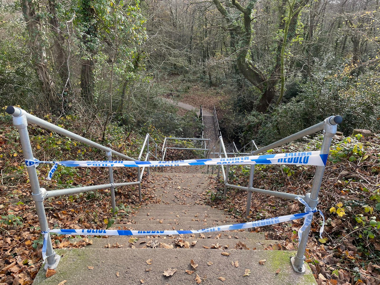 Steps to woodland behind the house have been taped off. (Bronwen Weatherby/PA)