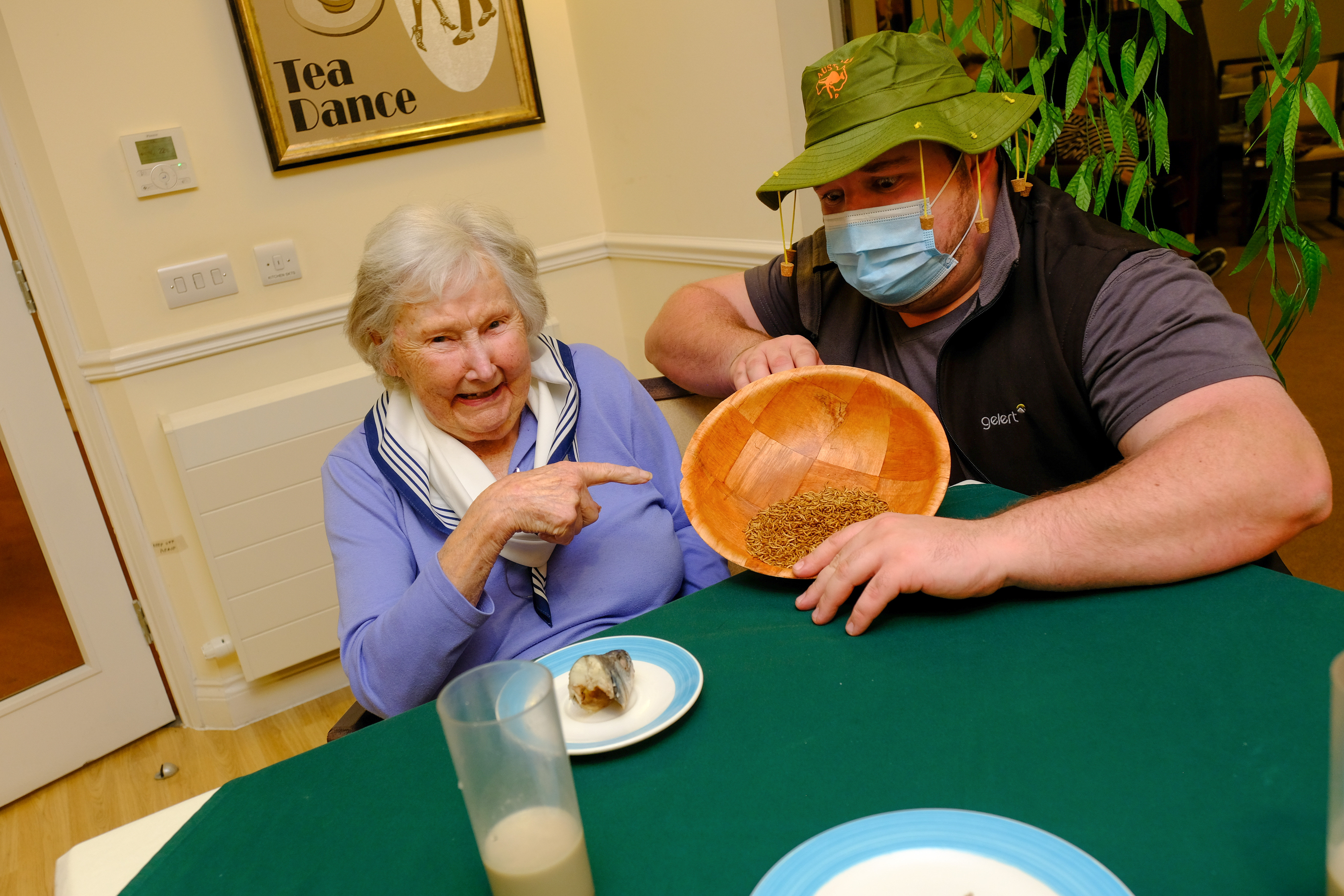 Doreen Barber, 96 with the care home's Lifestyle Lead Dan Bailey. Ms Barber said the insects were 'rather dry'. (Care UK/ PA)
