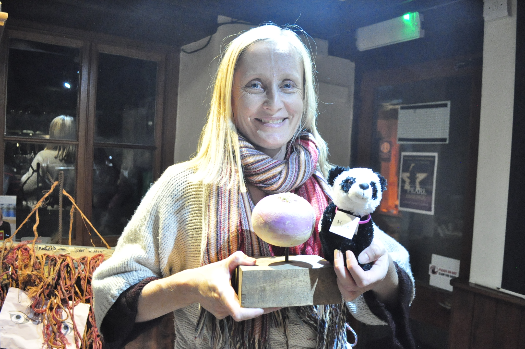 Emma Jones, the winner's representative, with the Turnip Prize and “Panda Mick” (A panda called Mick (Pandemic)) entry (Turnip Prize/PA).