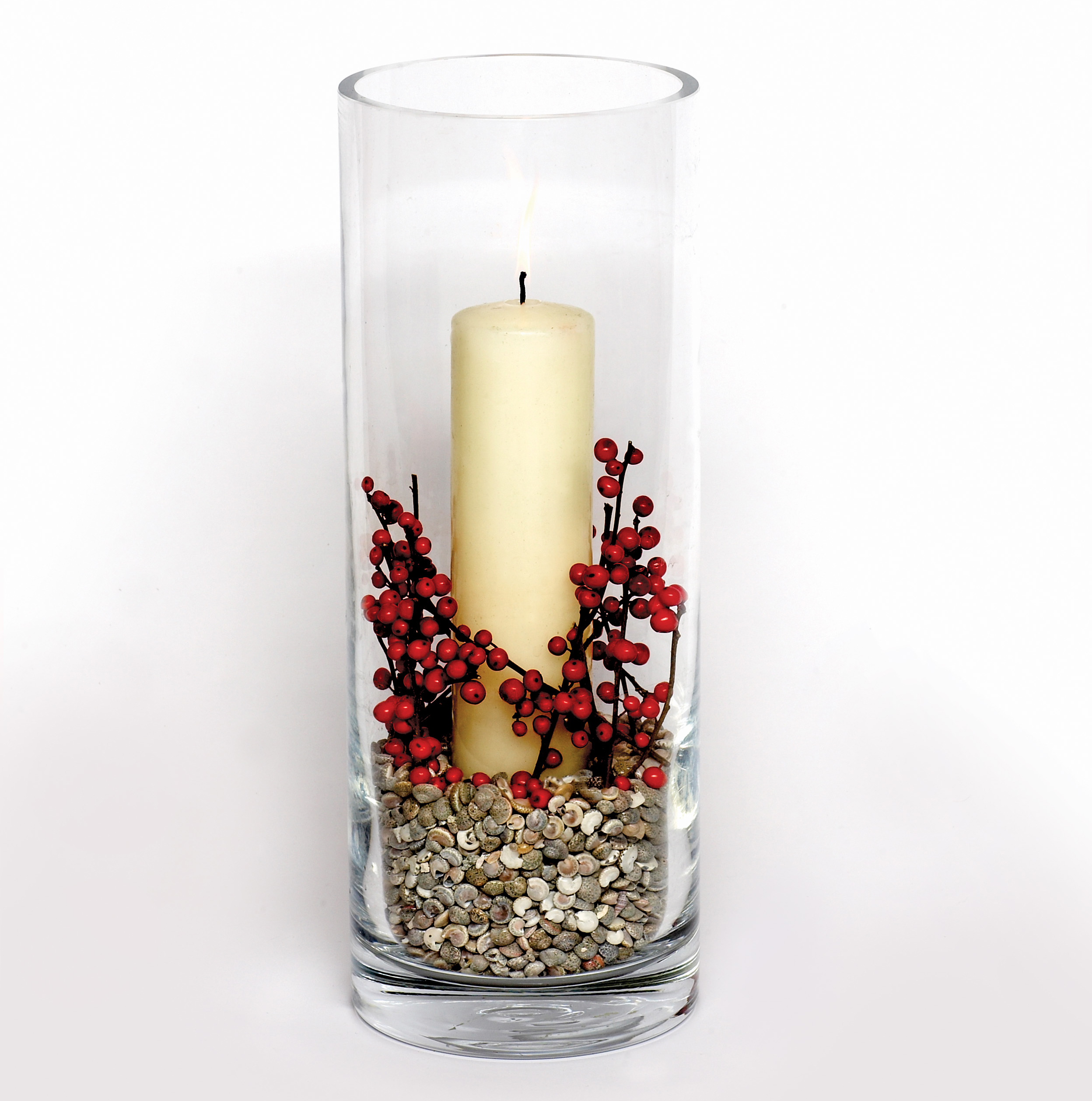 Glass vase with red berries, shells and church candle (Judith blacklock/PA)