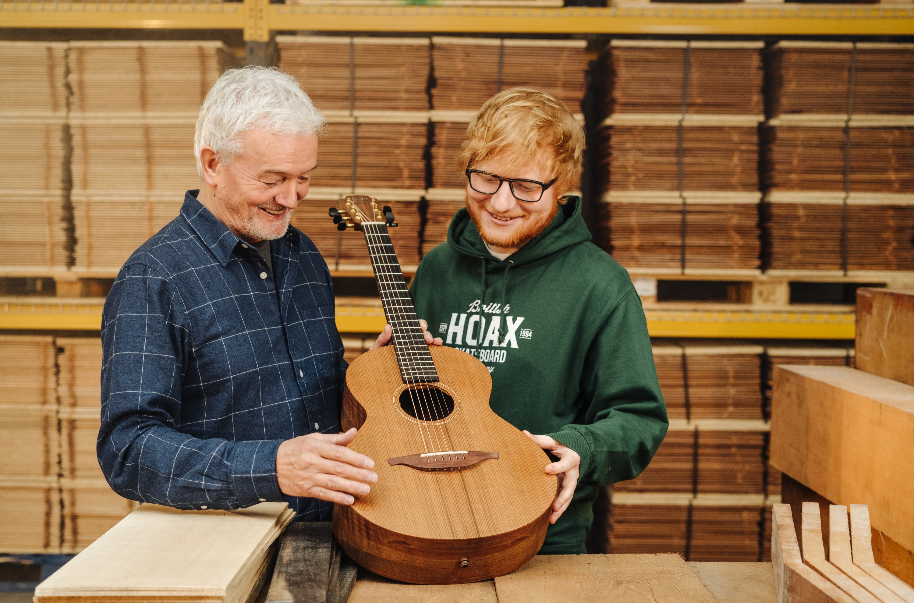 Ed Sheeran and guitar maker George Lowden with the prototype Equals guitar that Sheeran has donated as the prize in a charity raffle. (GeeWizz/ PA)
