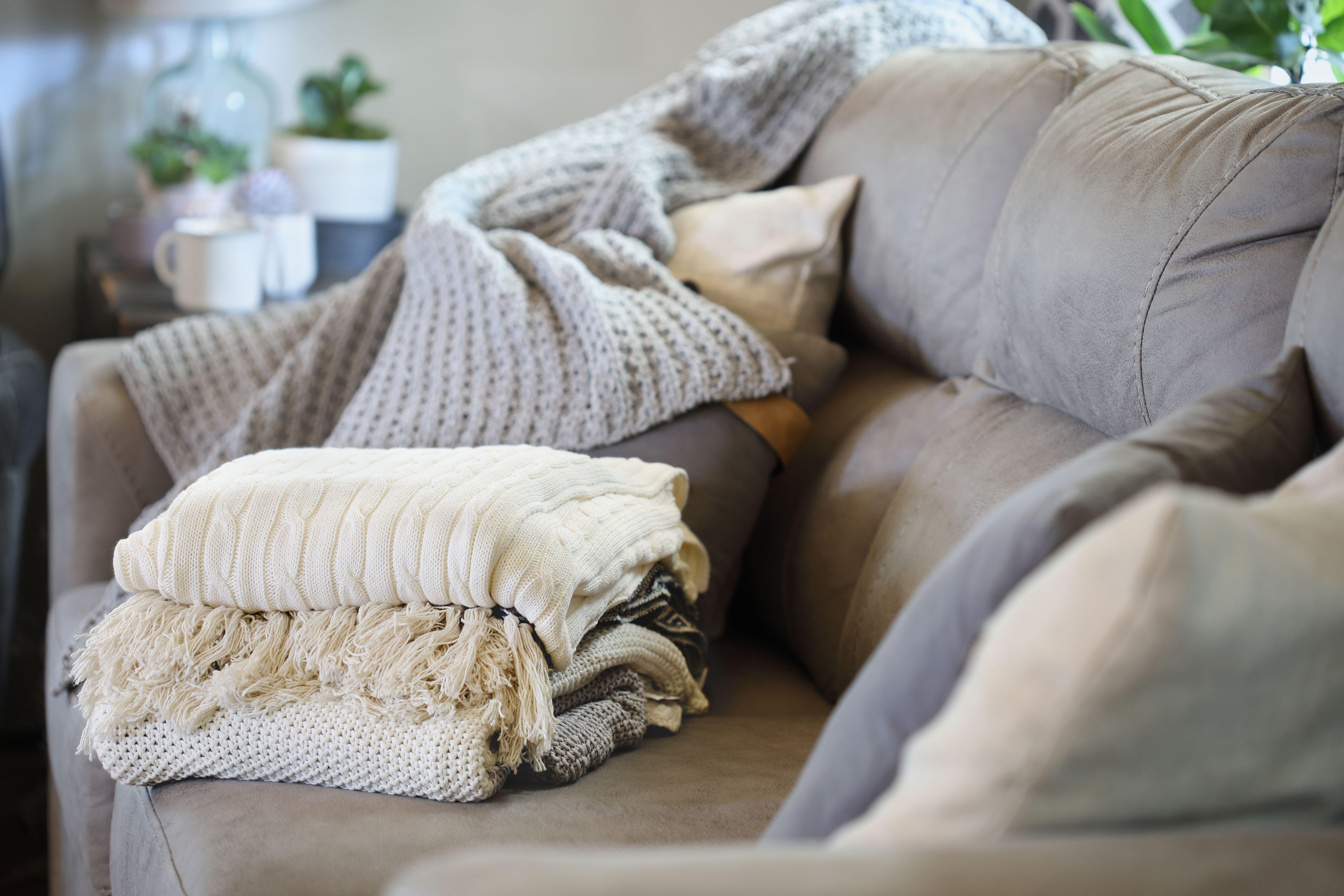 Stack of a variety of soft knit throw blankets 