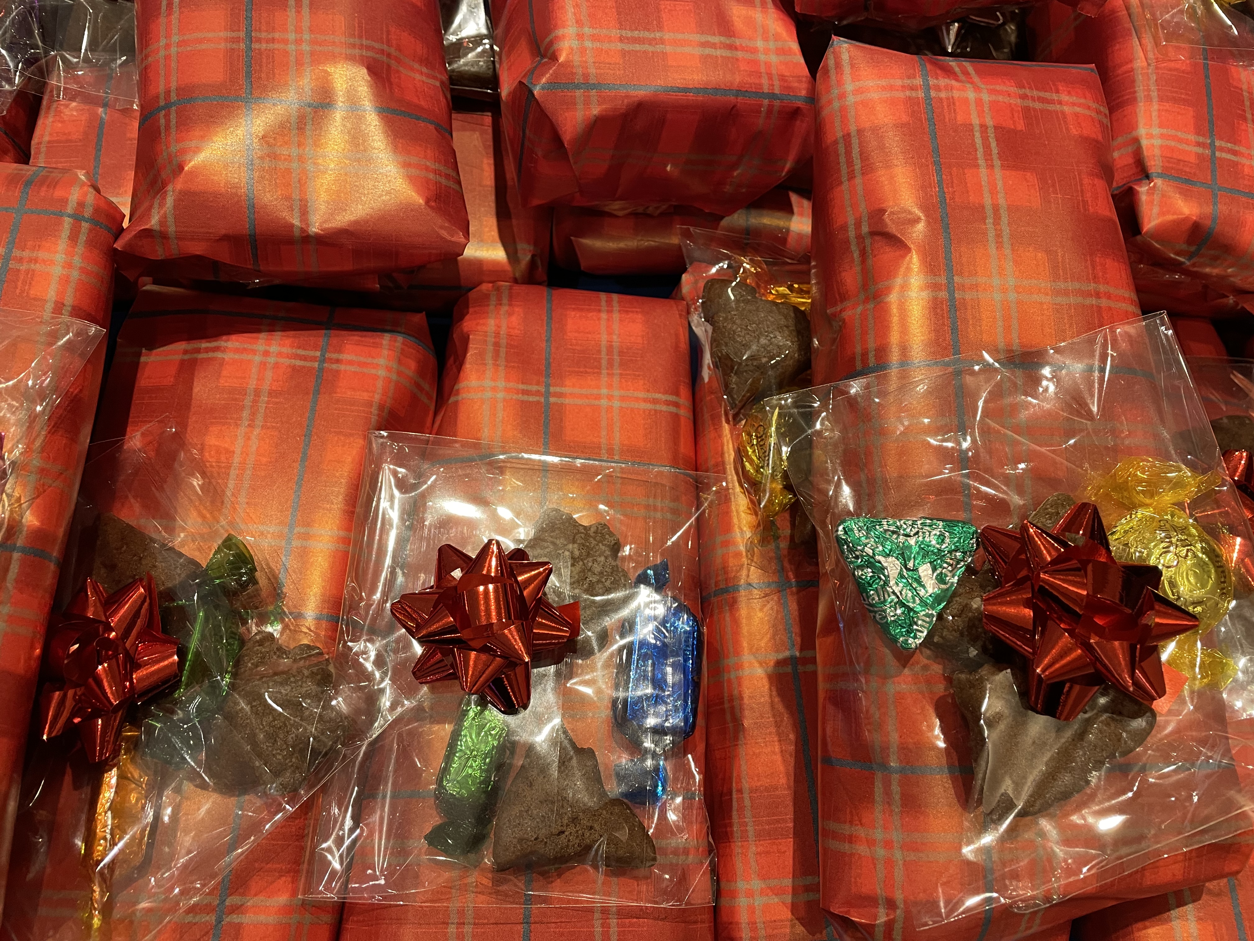 Wrapped socks, in red wrapping paper with ribbon bows and chocolates.