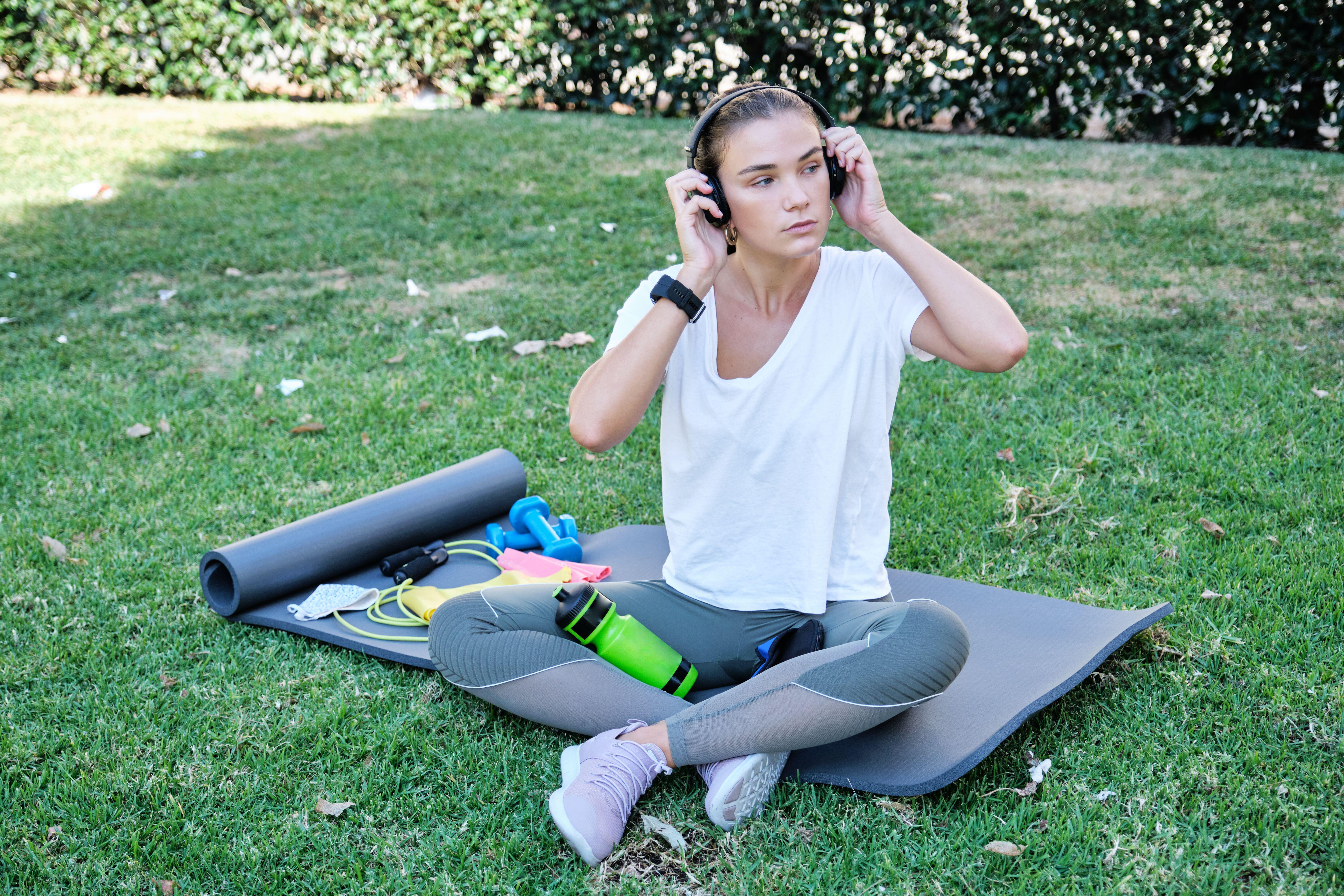 Woman in fitness gear on an exercise mat outdoors