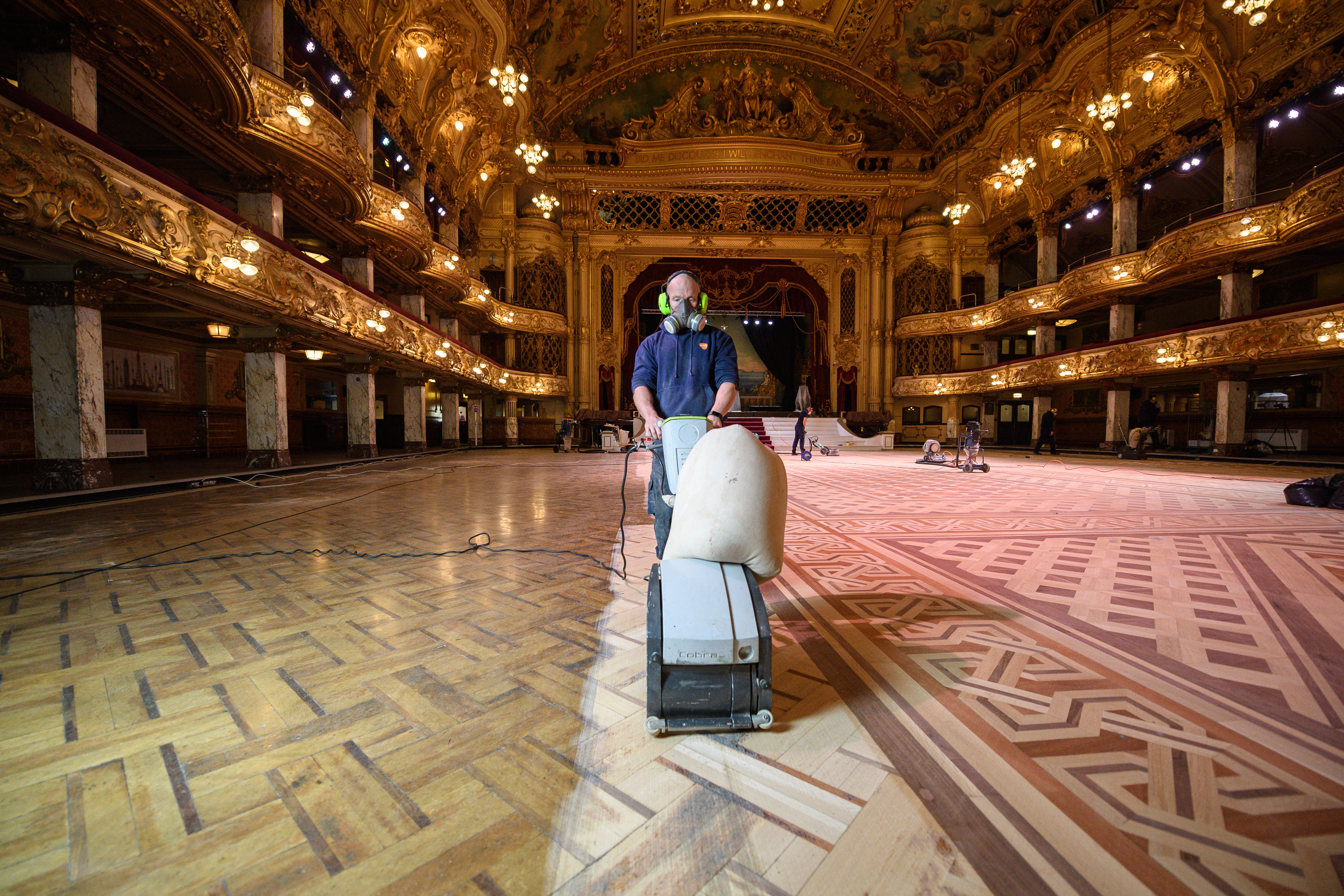 Gary King, a wood sanding technician, works to restore the floor of the historic Blackpool Tower Ballroom (Oli Scarff/Blackpool Tower/PA)