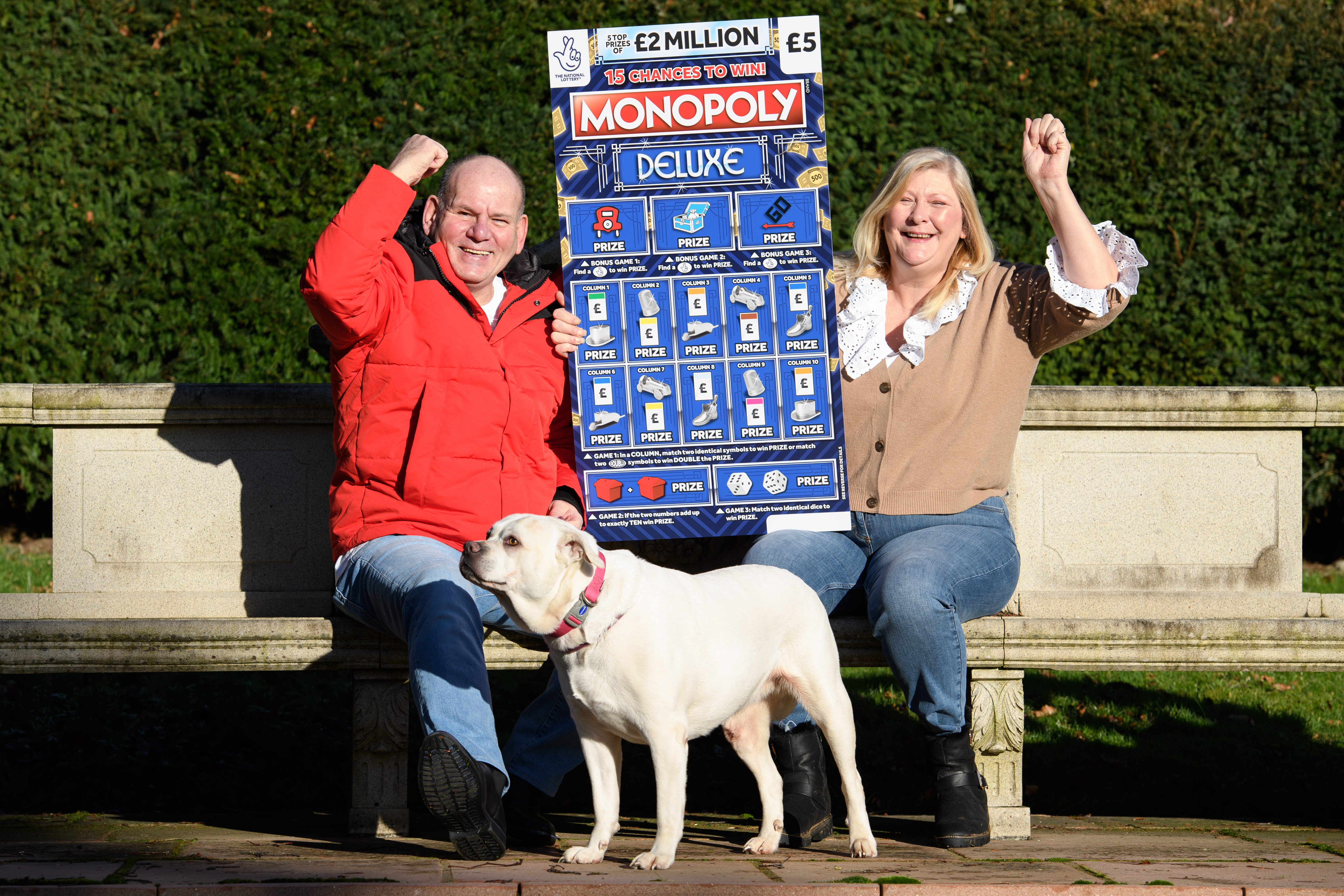 Ian and Sandra with their dog Meg. The couple say the first thing they do with their winnings is pay for Meg's operation. Undated image from Oli Scarff/Camelot