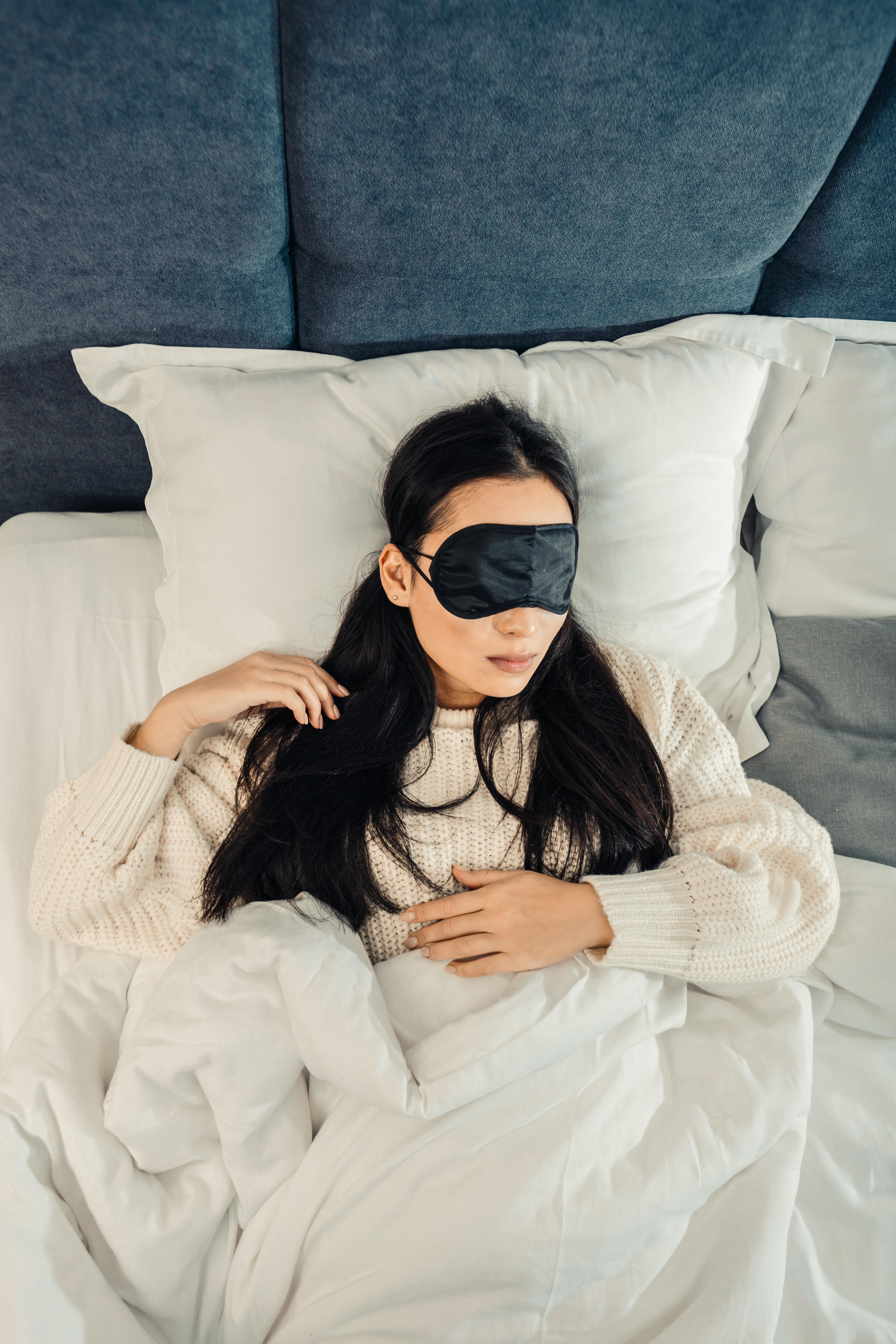 Woman in bed wearing eye mask