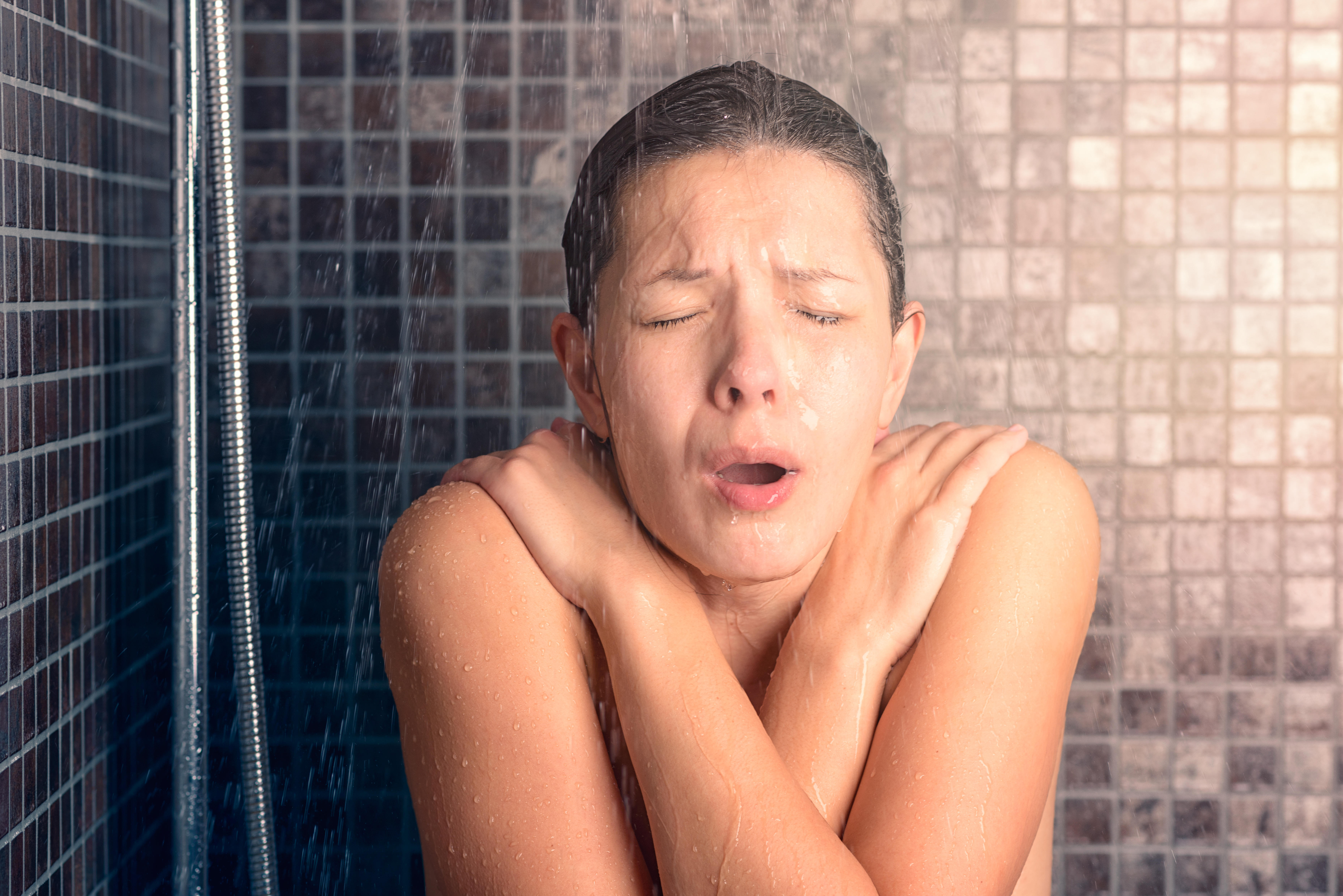 Woman shivering in cold water