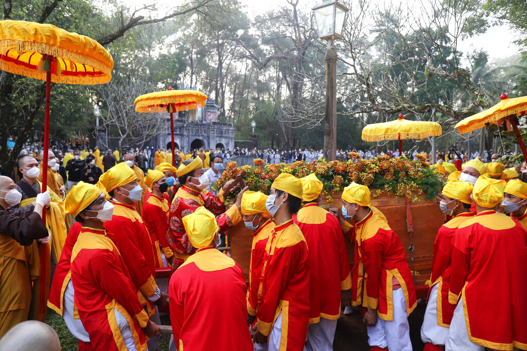 Pallbearers lift up the coffin of Vietnamese Buddhist monk Thich Nhat Hanh during his funeral in Hue, Vietnam Saturday, Jan. 29, 2022. A funeral was held Saturday for Thich Nhat Hanh, a week after the renowned Zen master died at the age of 95 in Hue in central Vietnam.