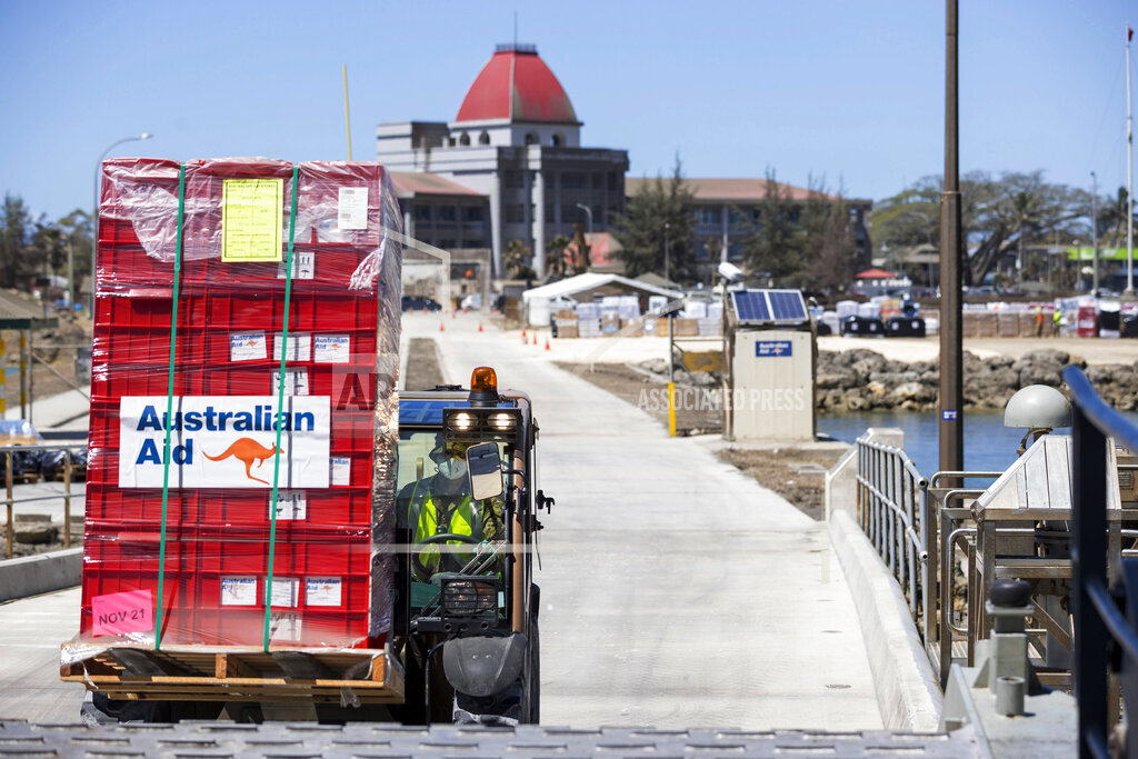 A la loader is used to move aid supplies at the port at Nuku'alofa, Tonga, 