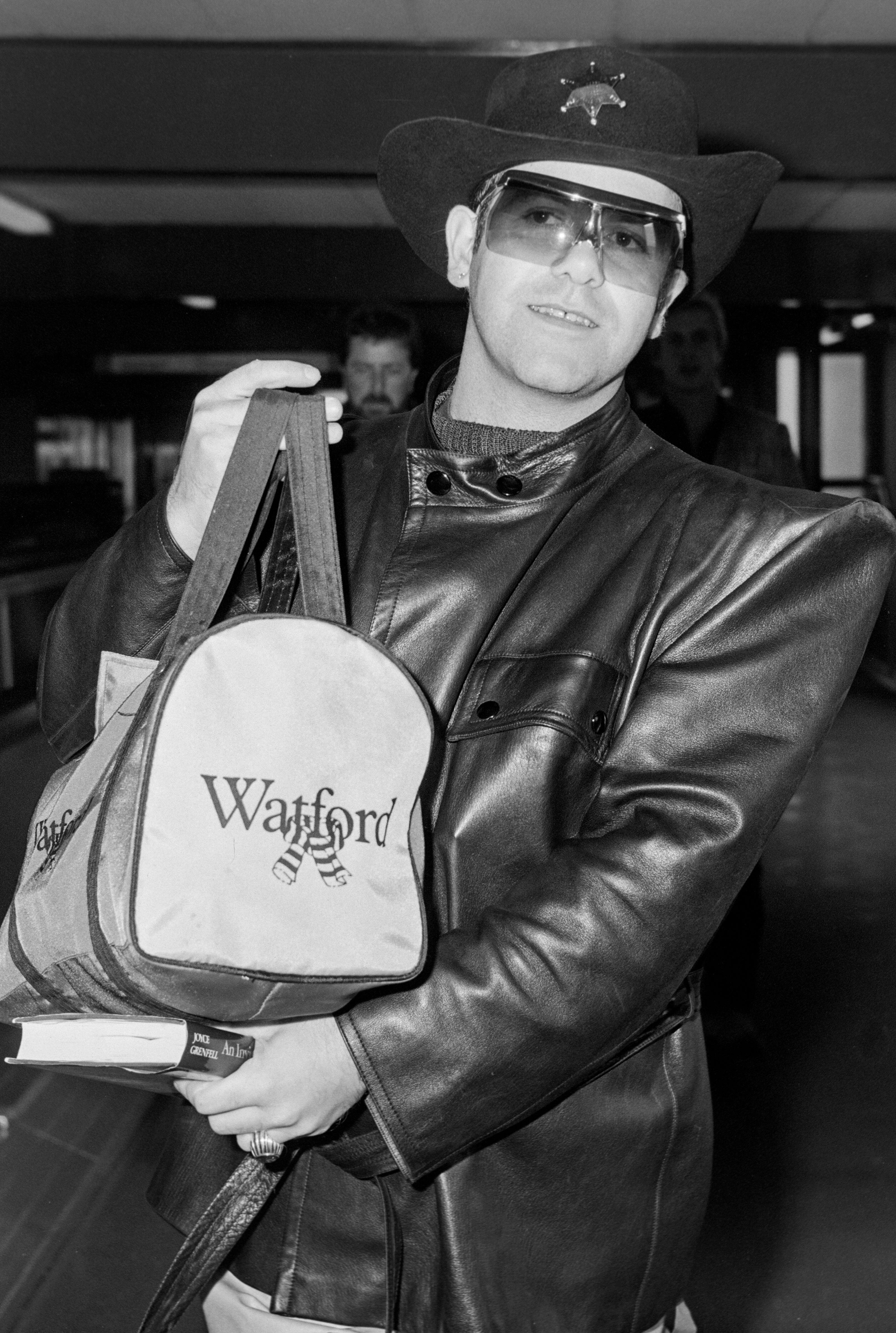 Elton John arriving at London's Heathrow airport in 1982