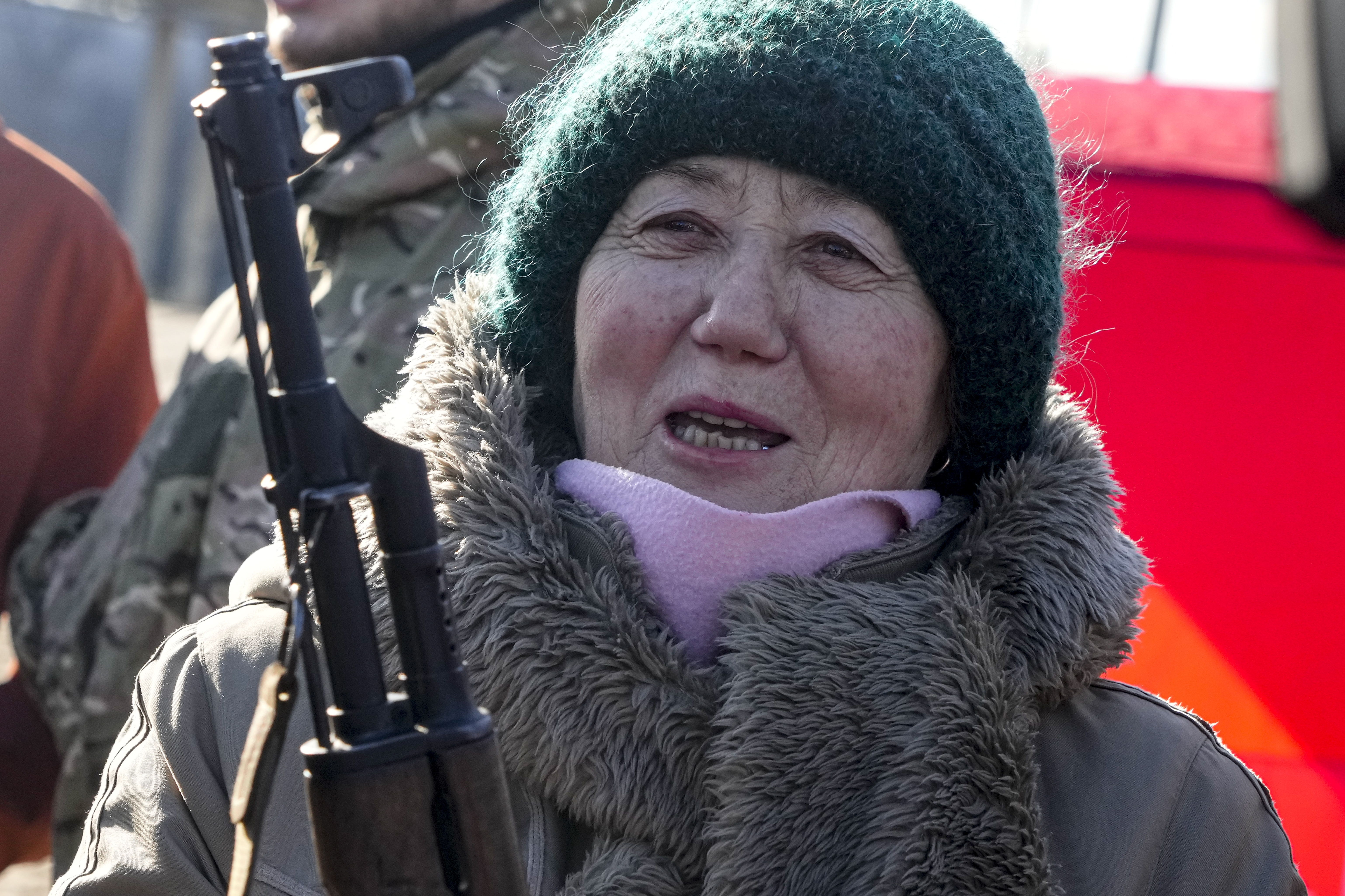 A woman practices using a Kalashnikov assault rifle in Kyiv 