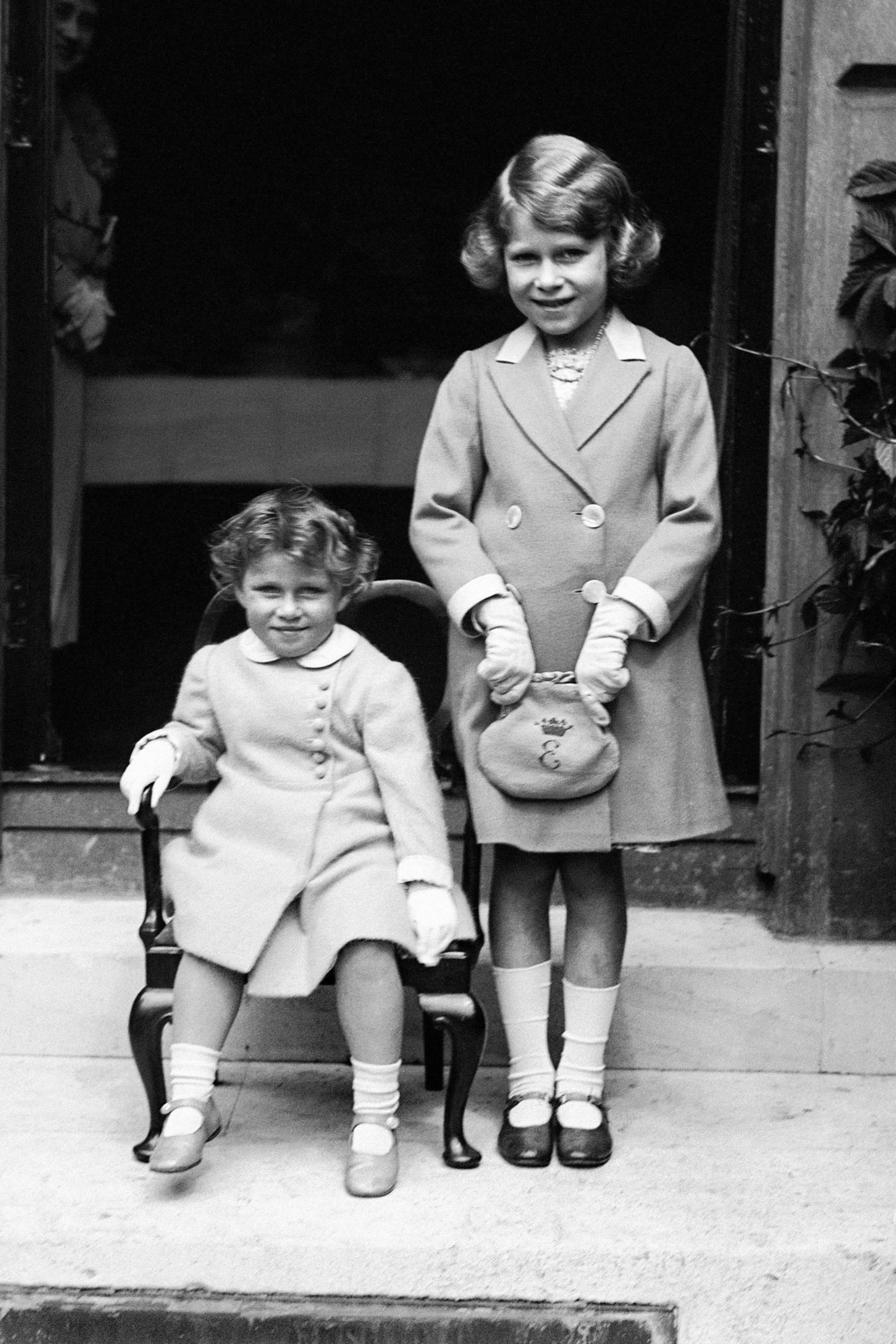 Two-year-old Princess Margaret (seated) with her sister Princess Elizabeth, aged seven