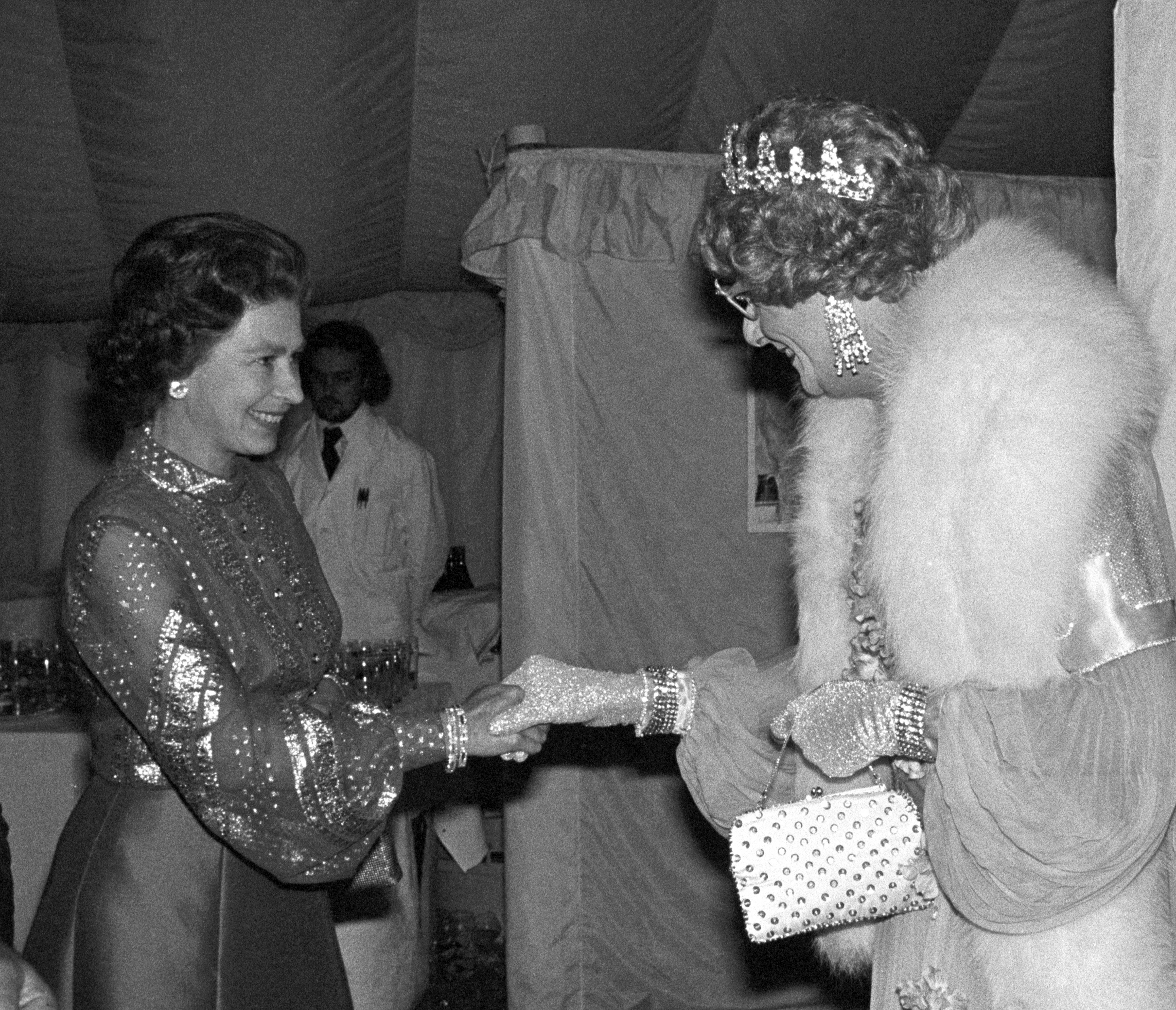 Queen Elizabeth II meets Dame Edna Everage - the creation of Australian humourist Barry Humphries at Windsor, when he was among the host stars appearing in the gala variety performance in the Big top at home Park in aid of the Queen's Silver Jubilee Appeal