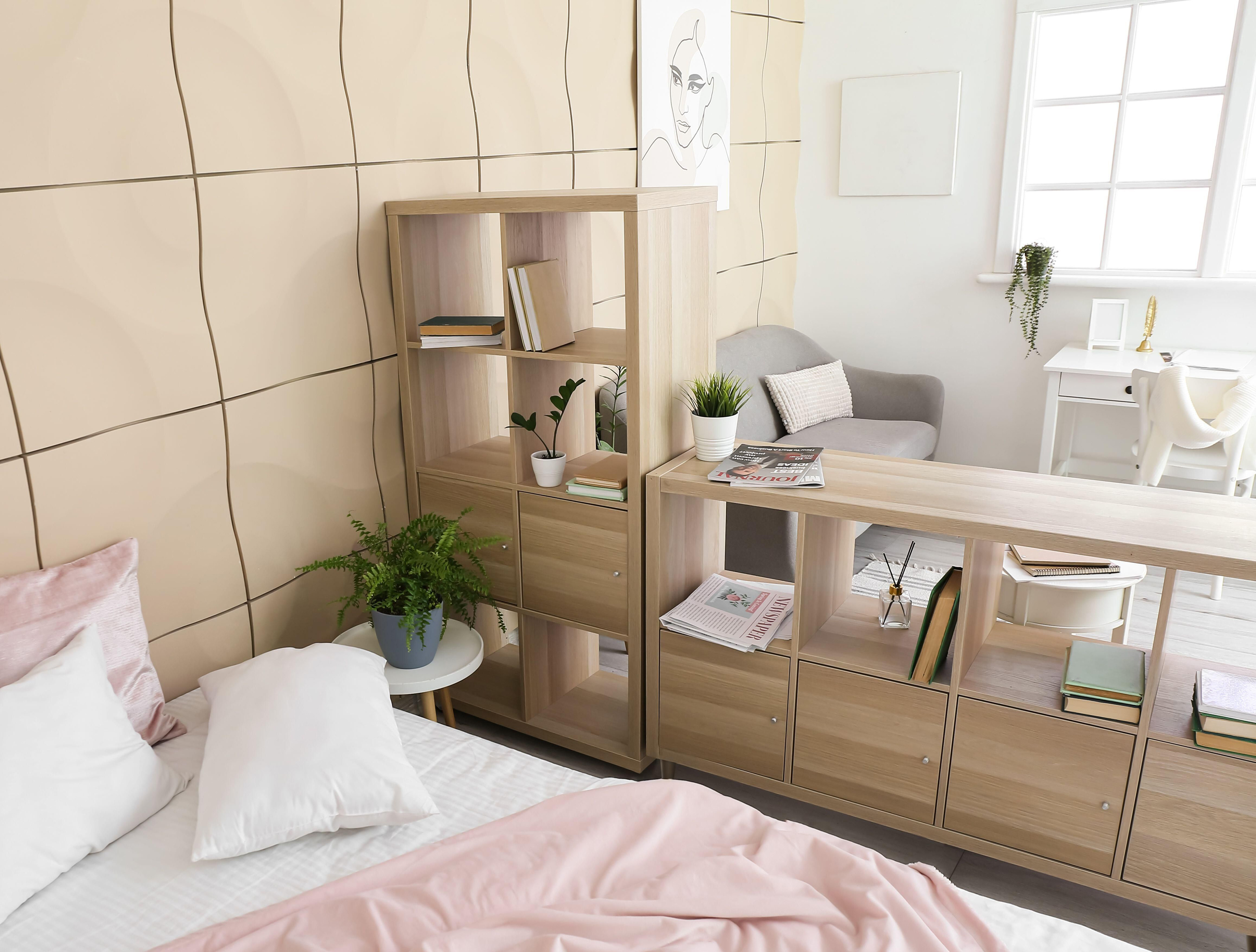 Wooden book shelf dividing a small living space 