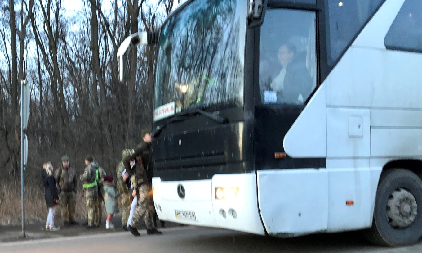 Ukrainian soldiers pulling men off bus