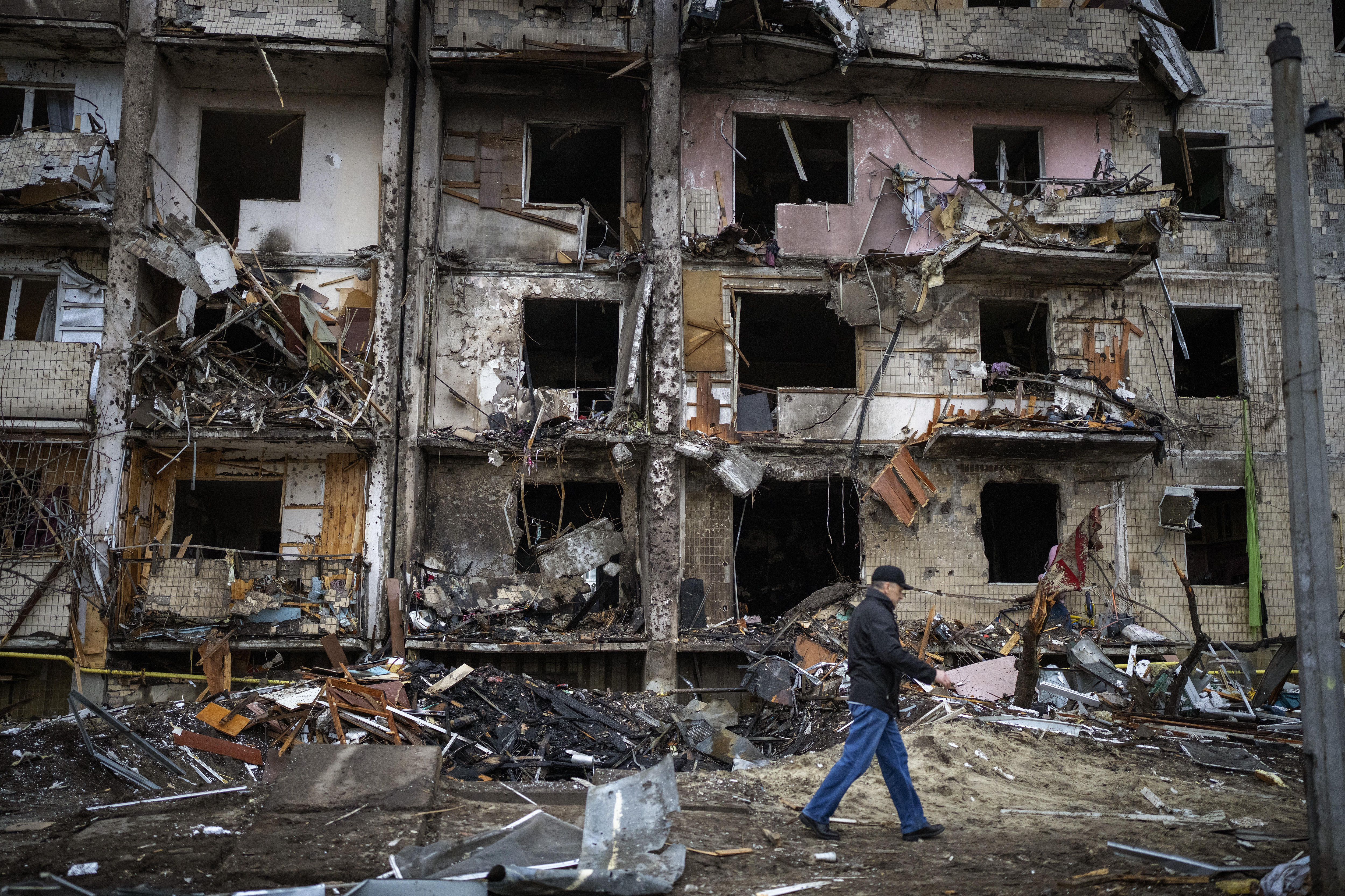 A man walks past a building damaged following a rocket attack the city of Kyiv, Ukraine, 