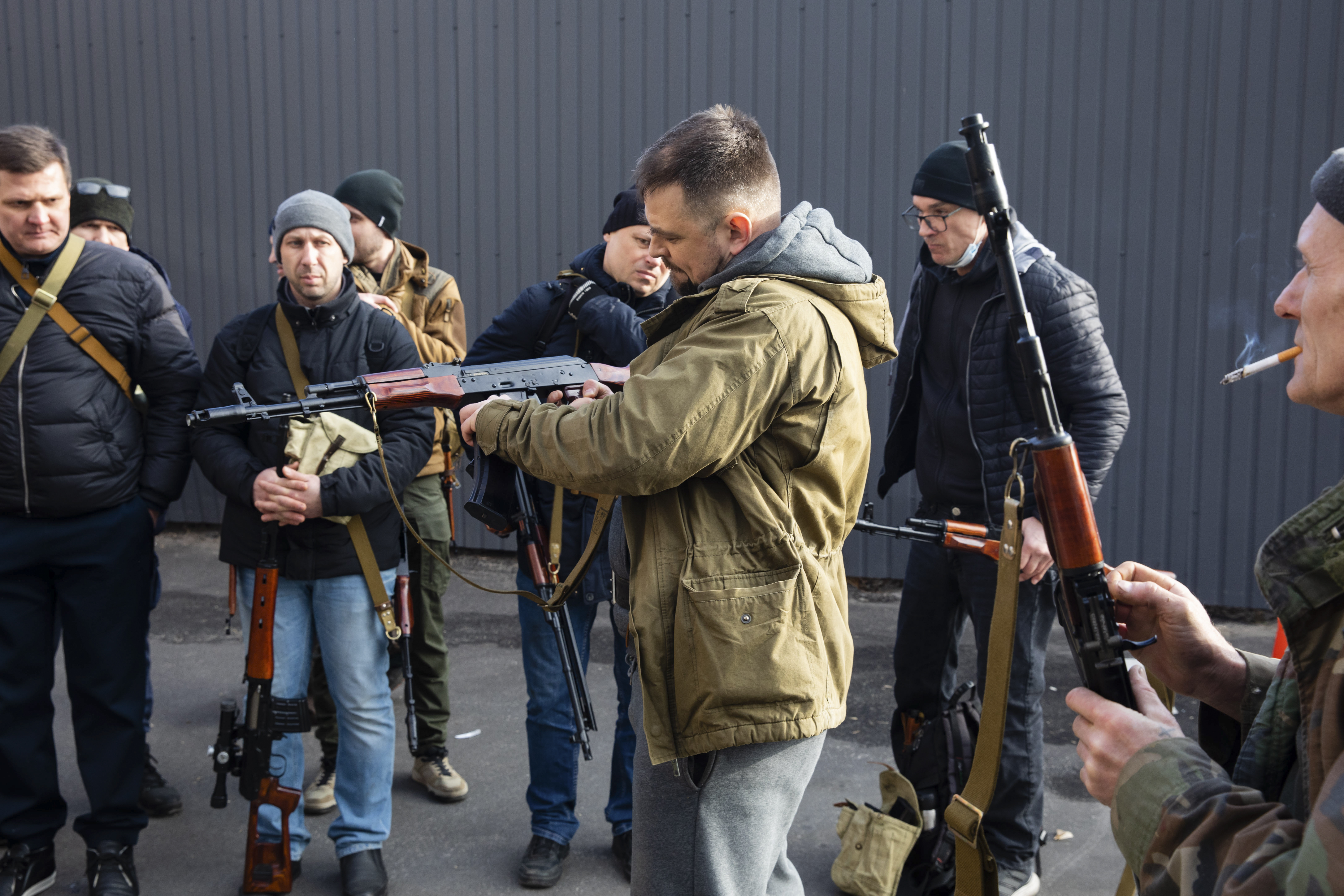 Civilian Members of a territorial defence unit fit their weapons to repel the Russian attacking forces in Kyiv 