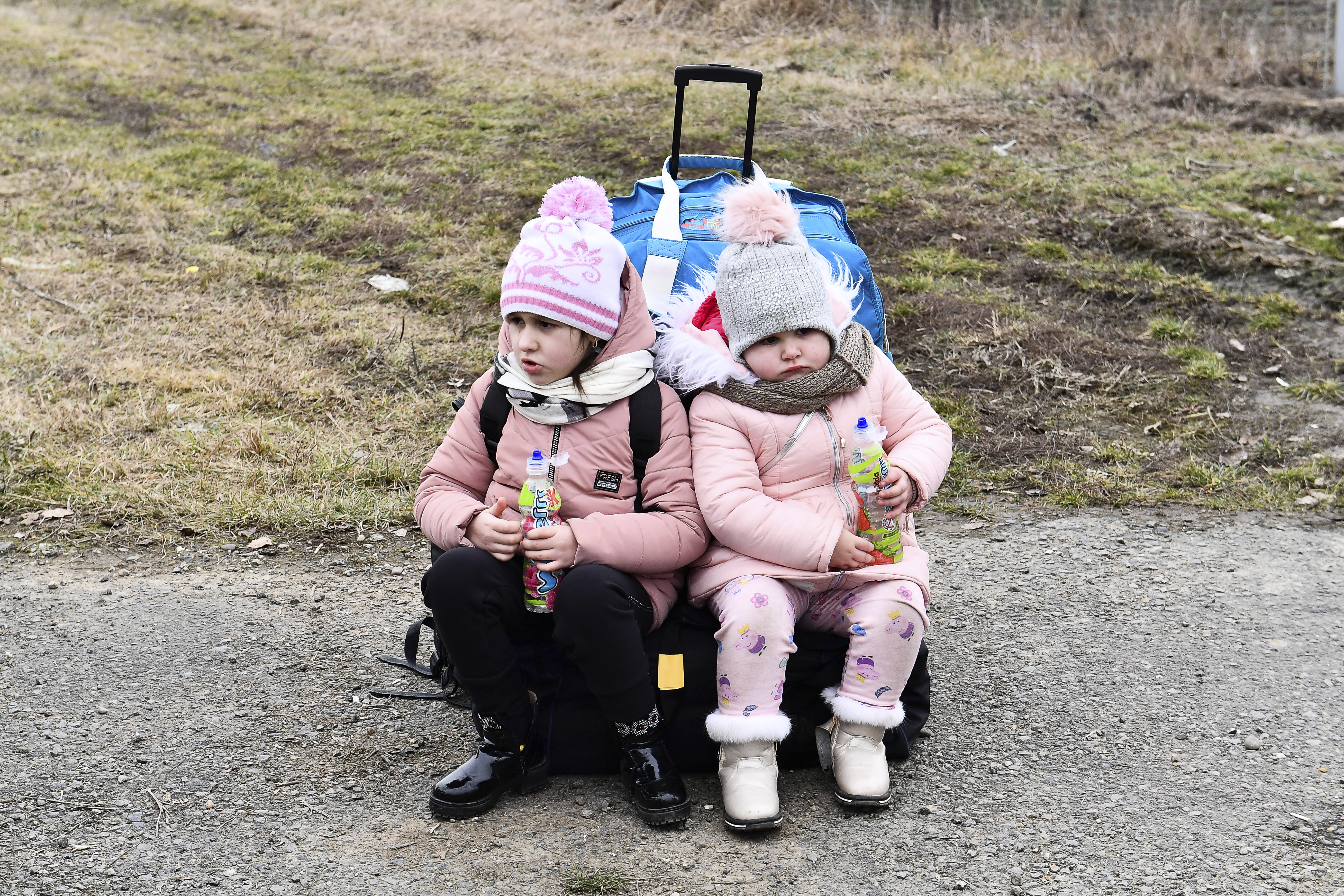 Sisters wait at a checkpoint run by local volunteers 