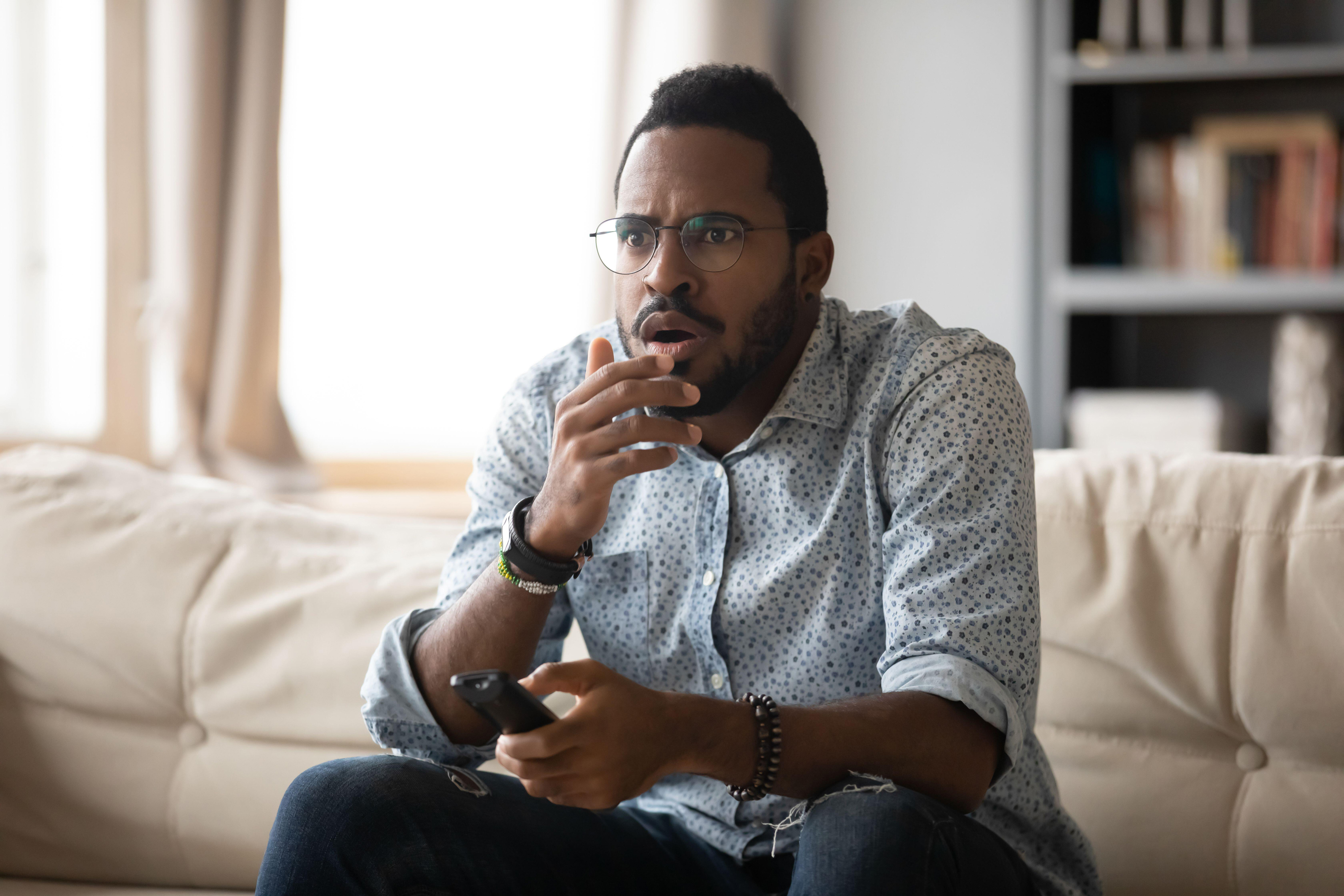 Anxious man watching TV