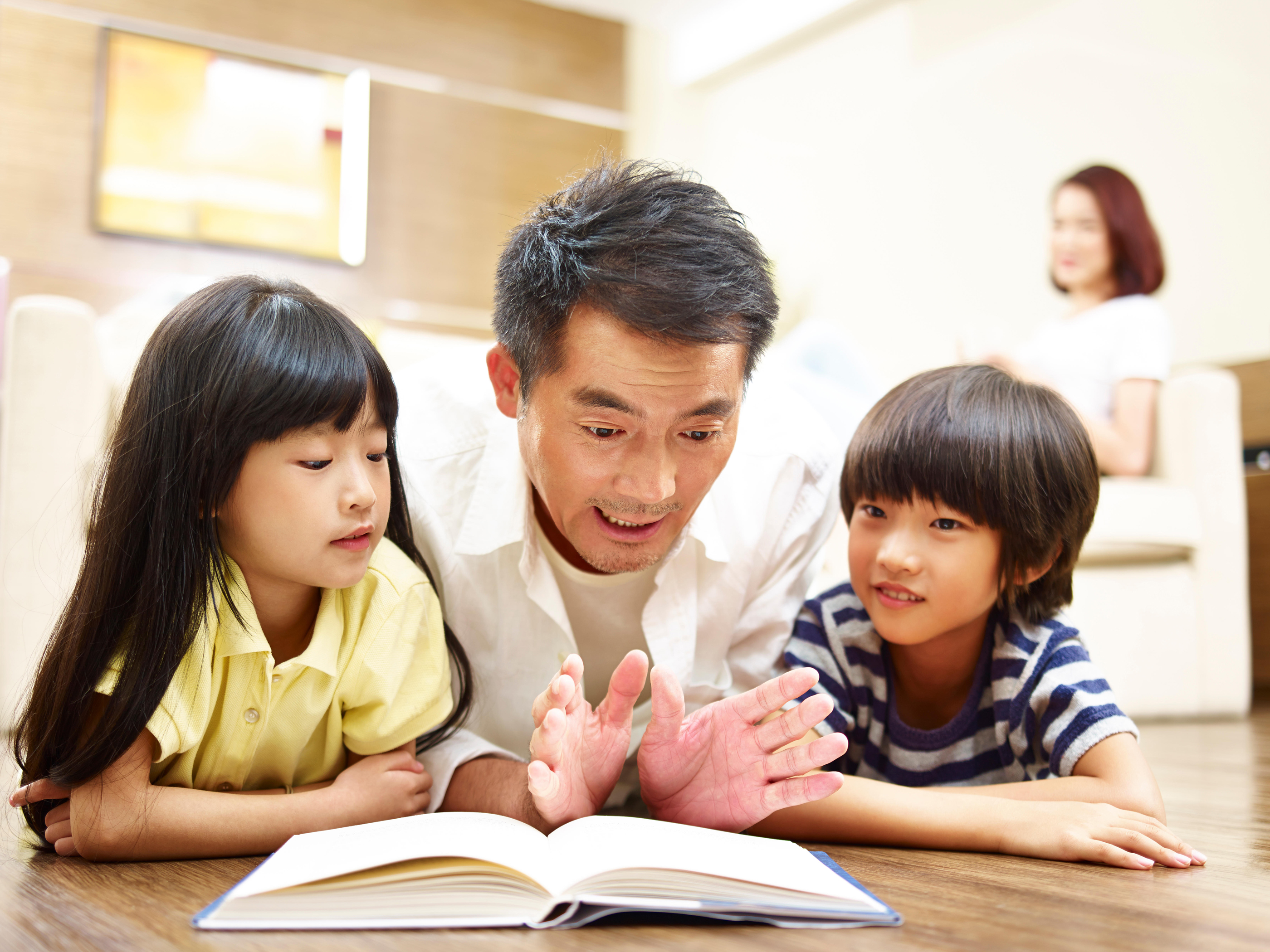Dad reading with two children