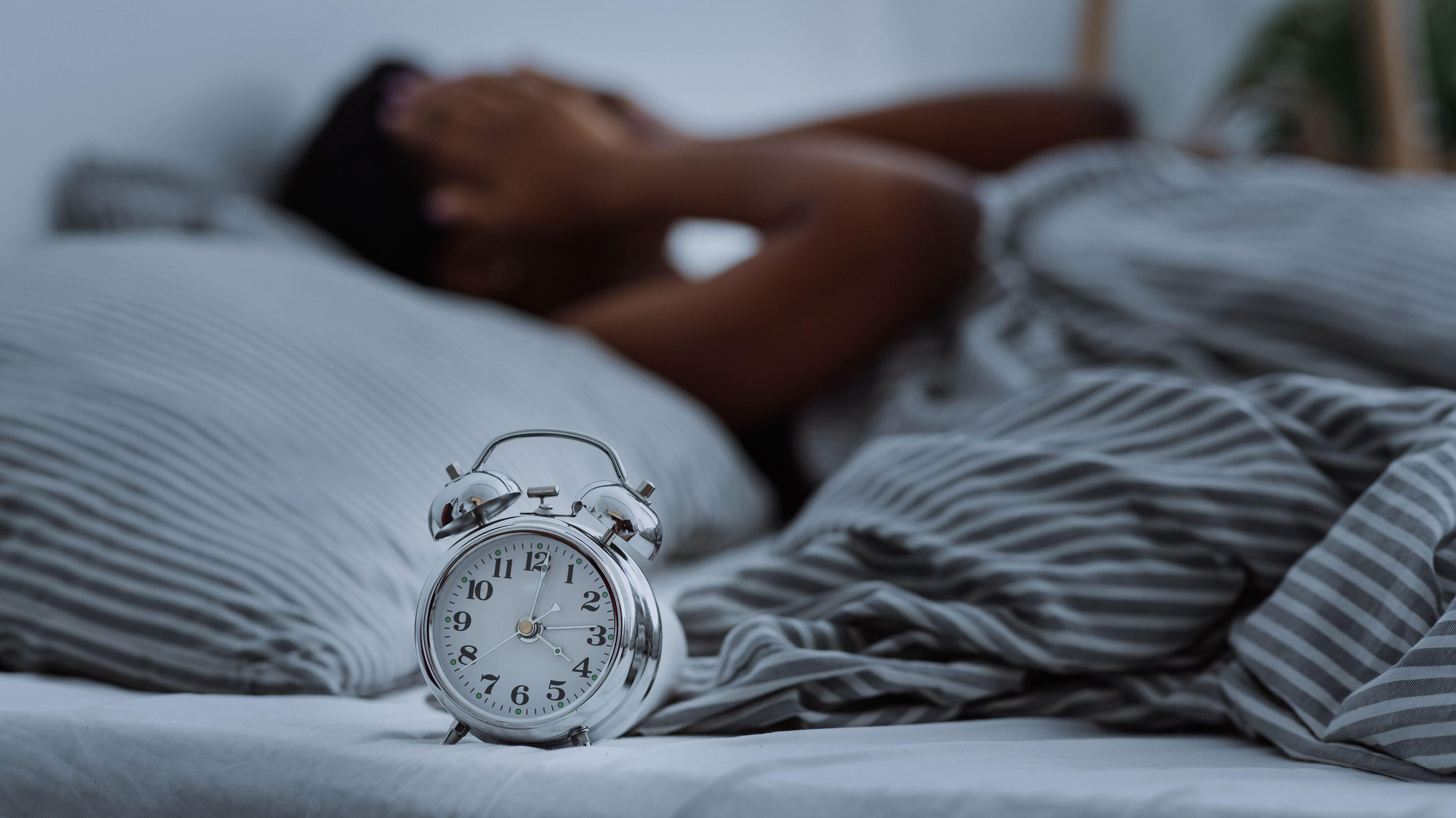 Woman lying in bed trying to get some sleep