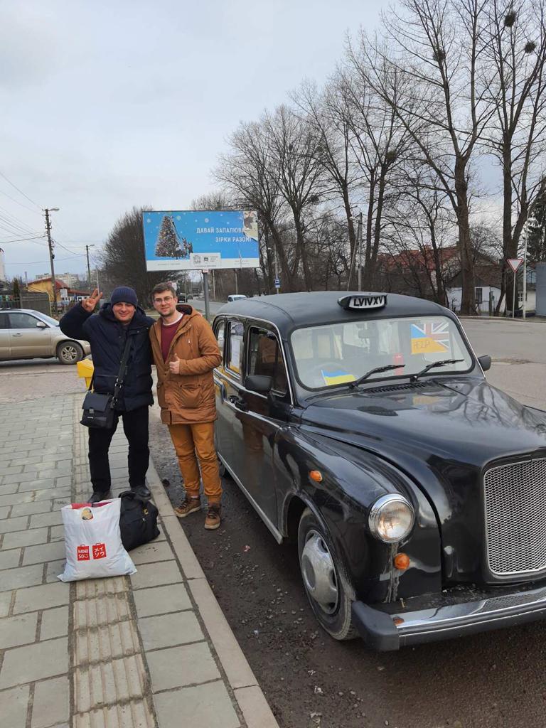 Roman Tymchyshyn with one of his passengers travelling across the Polish border in his black cab.