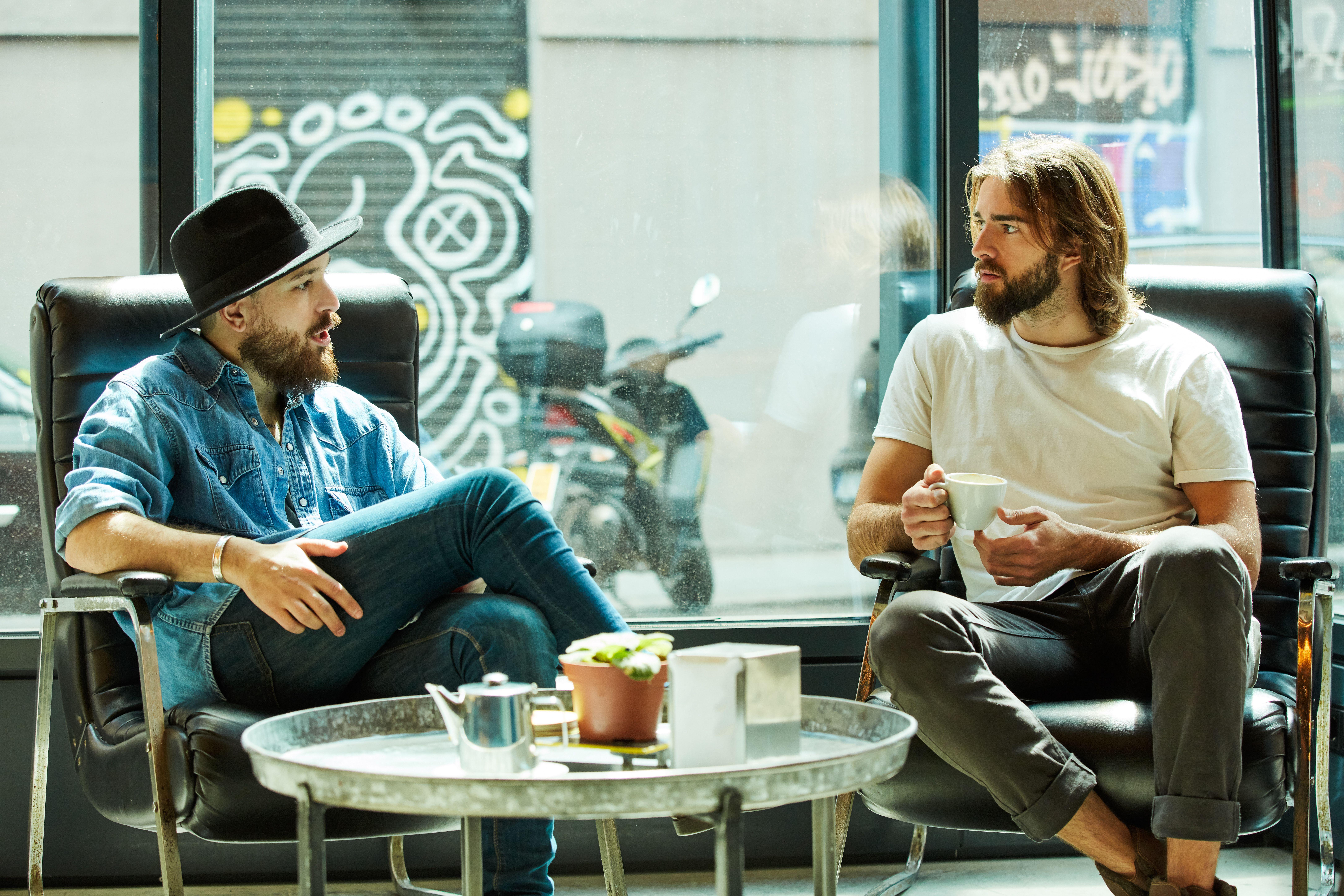 Two male friends having coffee