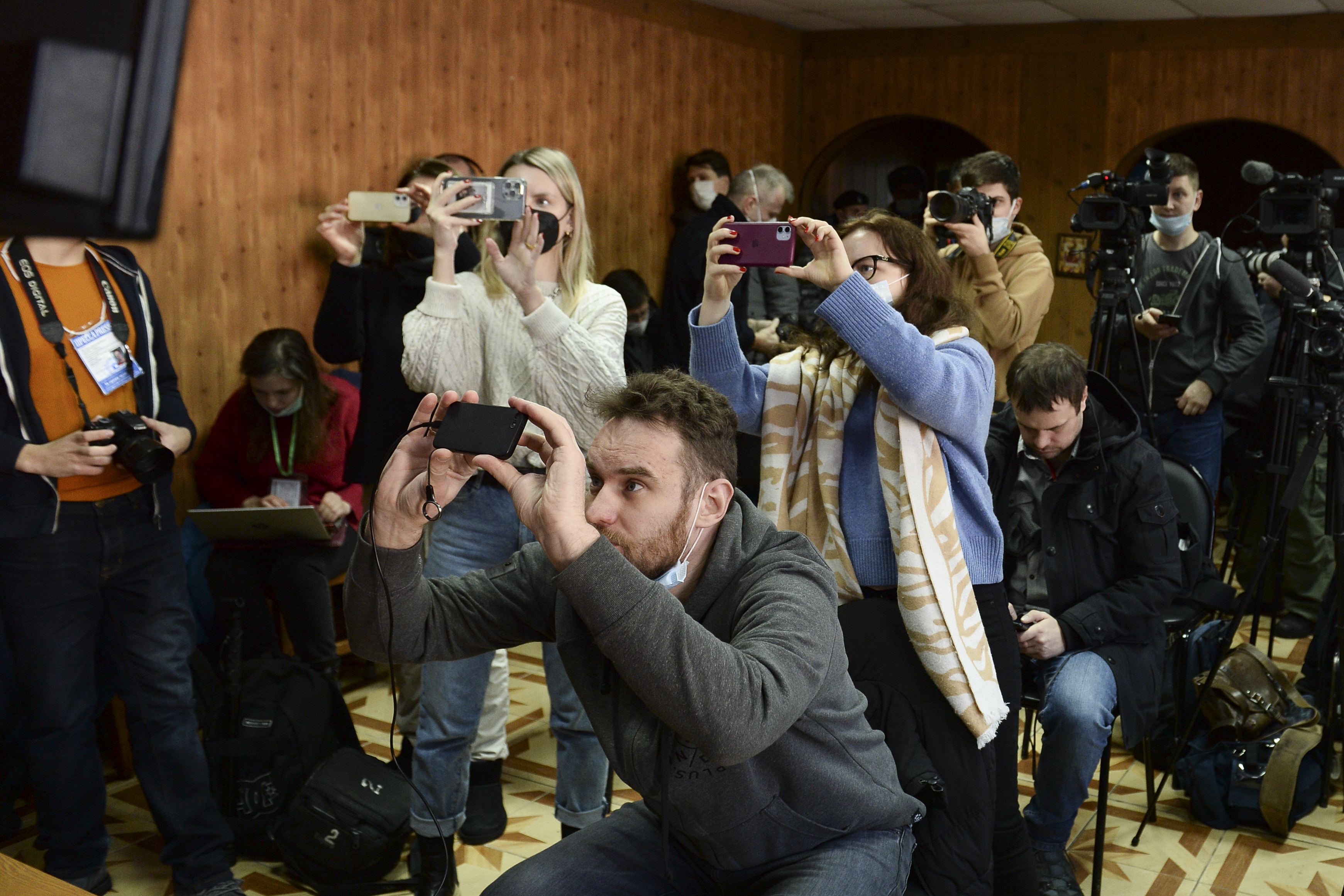 Photographers take images of the proceedings