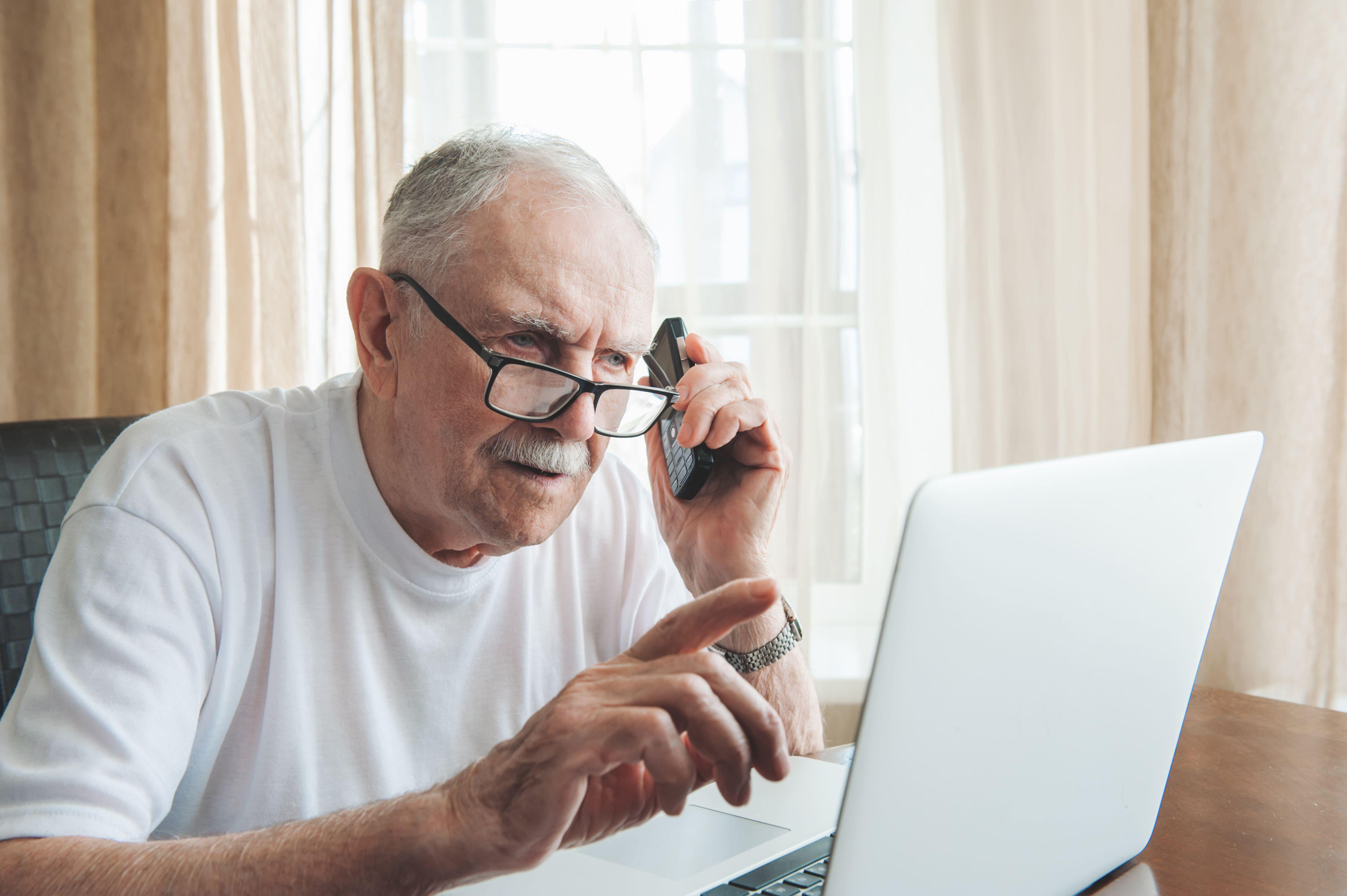 Man on phone and laptop