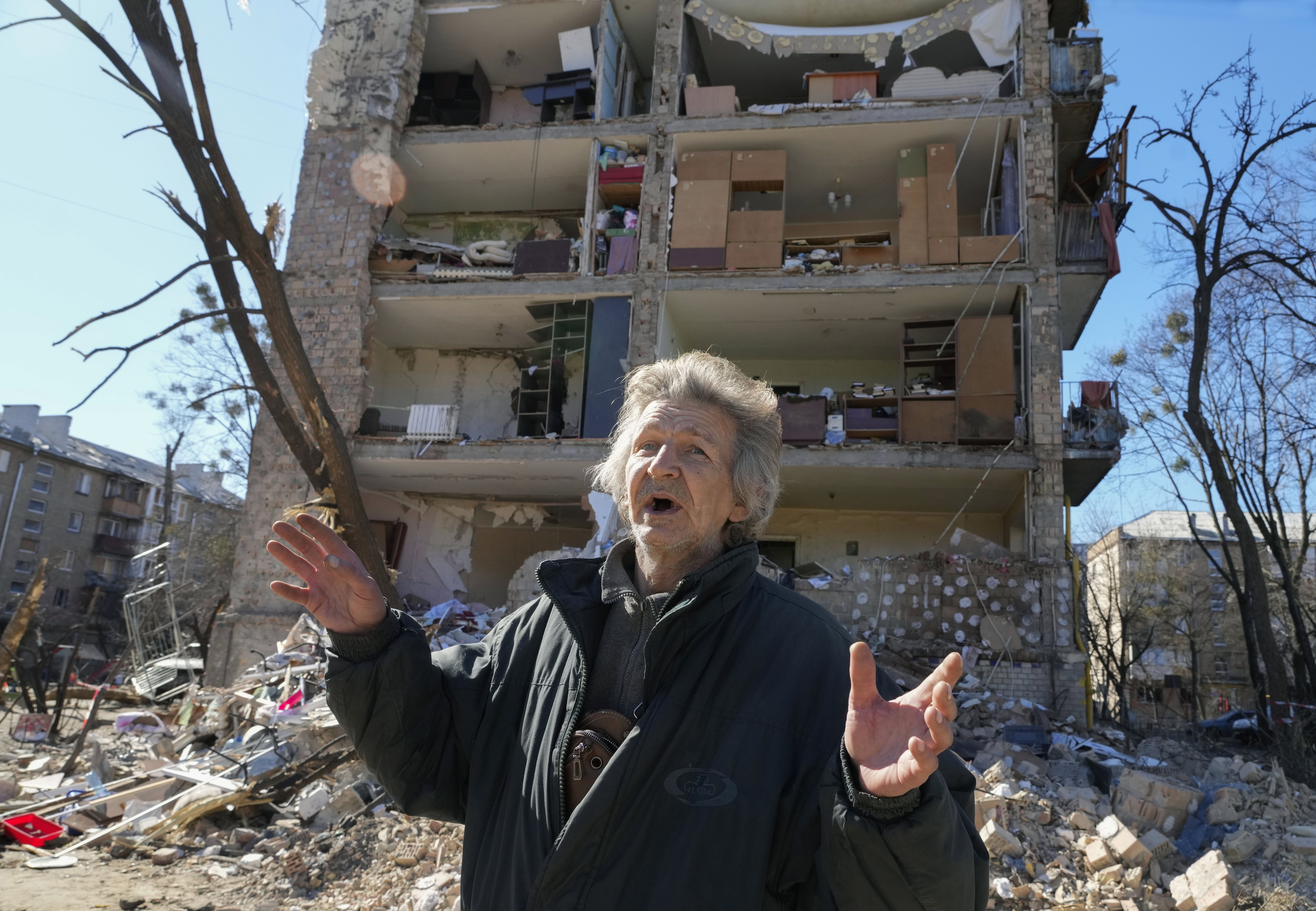 A man reacts standing near his house ruined after Russian shelling in Kyiv, Ukraine, Monday, March 21, 2022. At least eight people were killed in the attack. (Efrem Lukatsky/AP)
