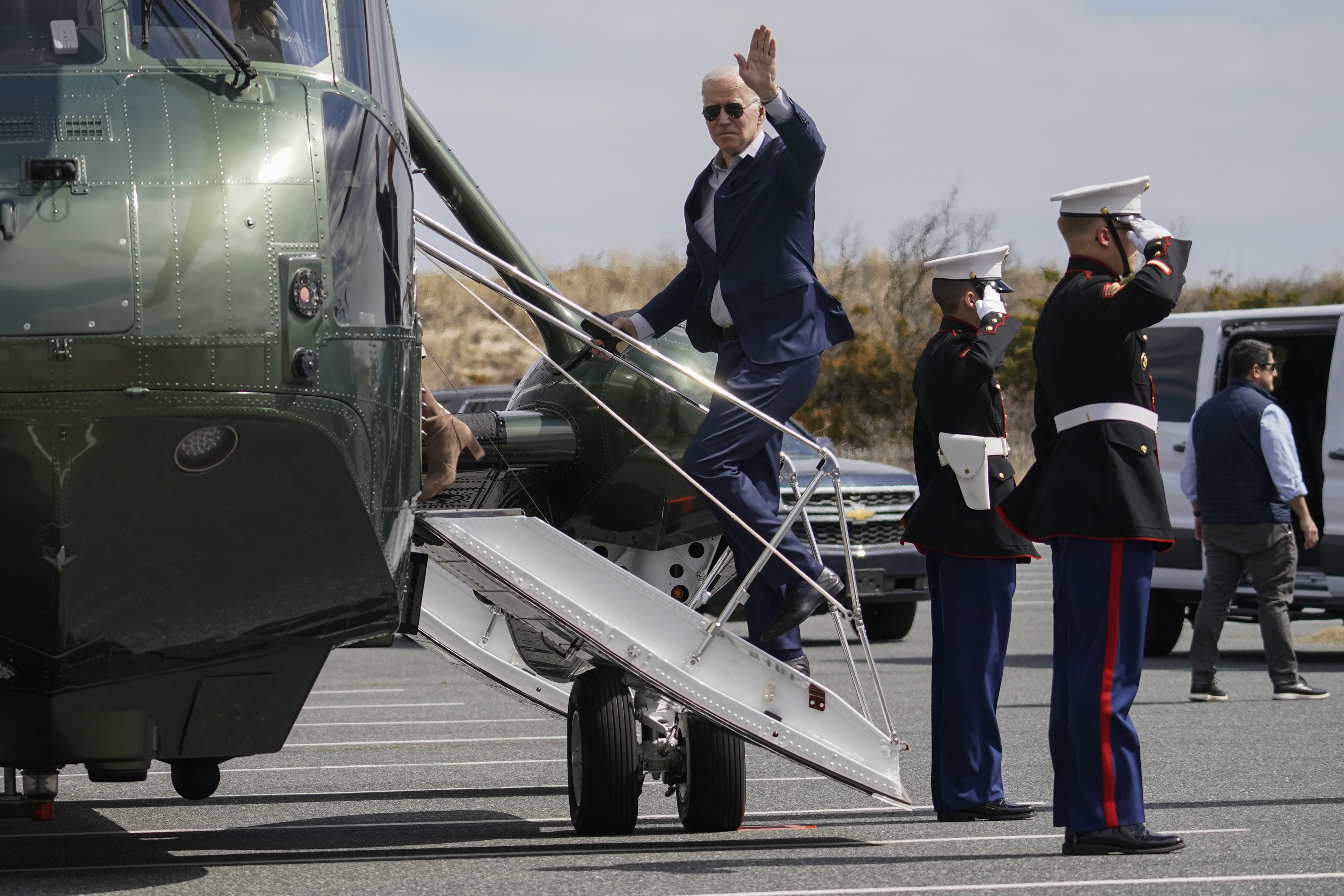President Joe Biden waves as he and and first lady Jill Biden board Marine One in Rehoboth Beach, Del., Sunday, March 20, 2022, en route to Washington. 