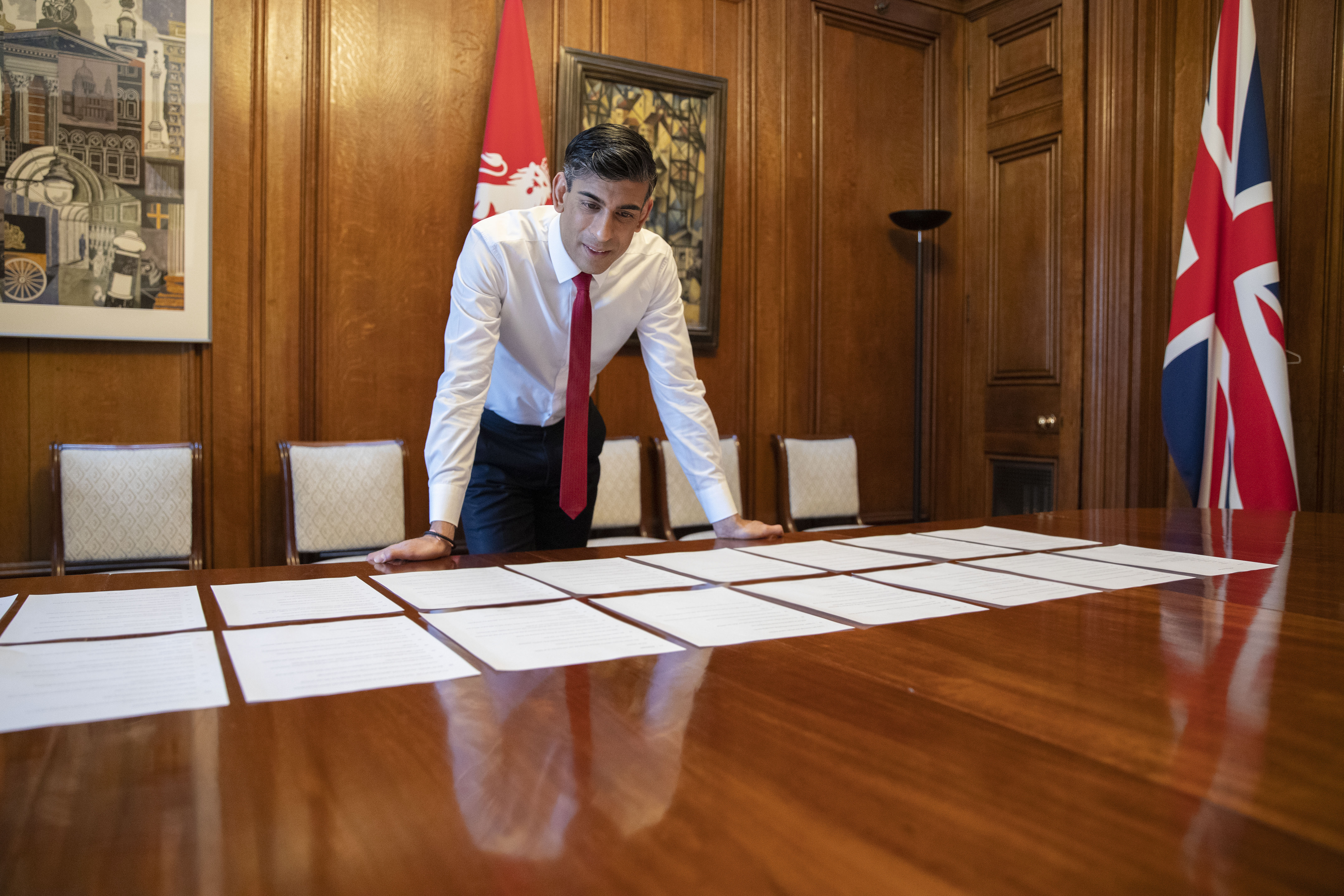 Rishi Sunak looking at paper on a desk preparing for the Spring Statement