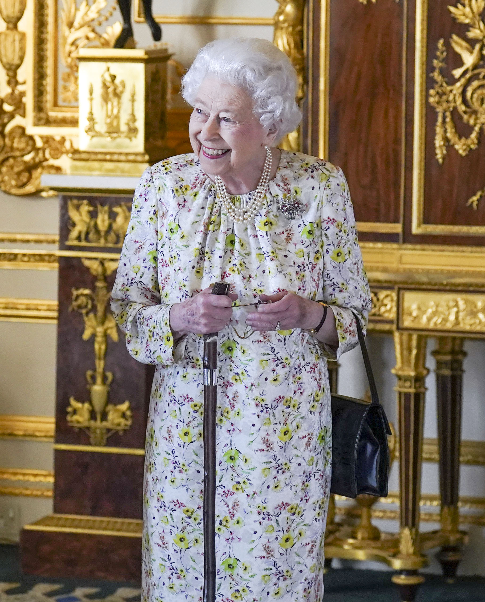 The Queen in a spring floral dress for the engagement in the White Drawing Room at Windsor Castle 
