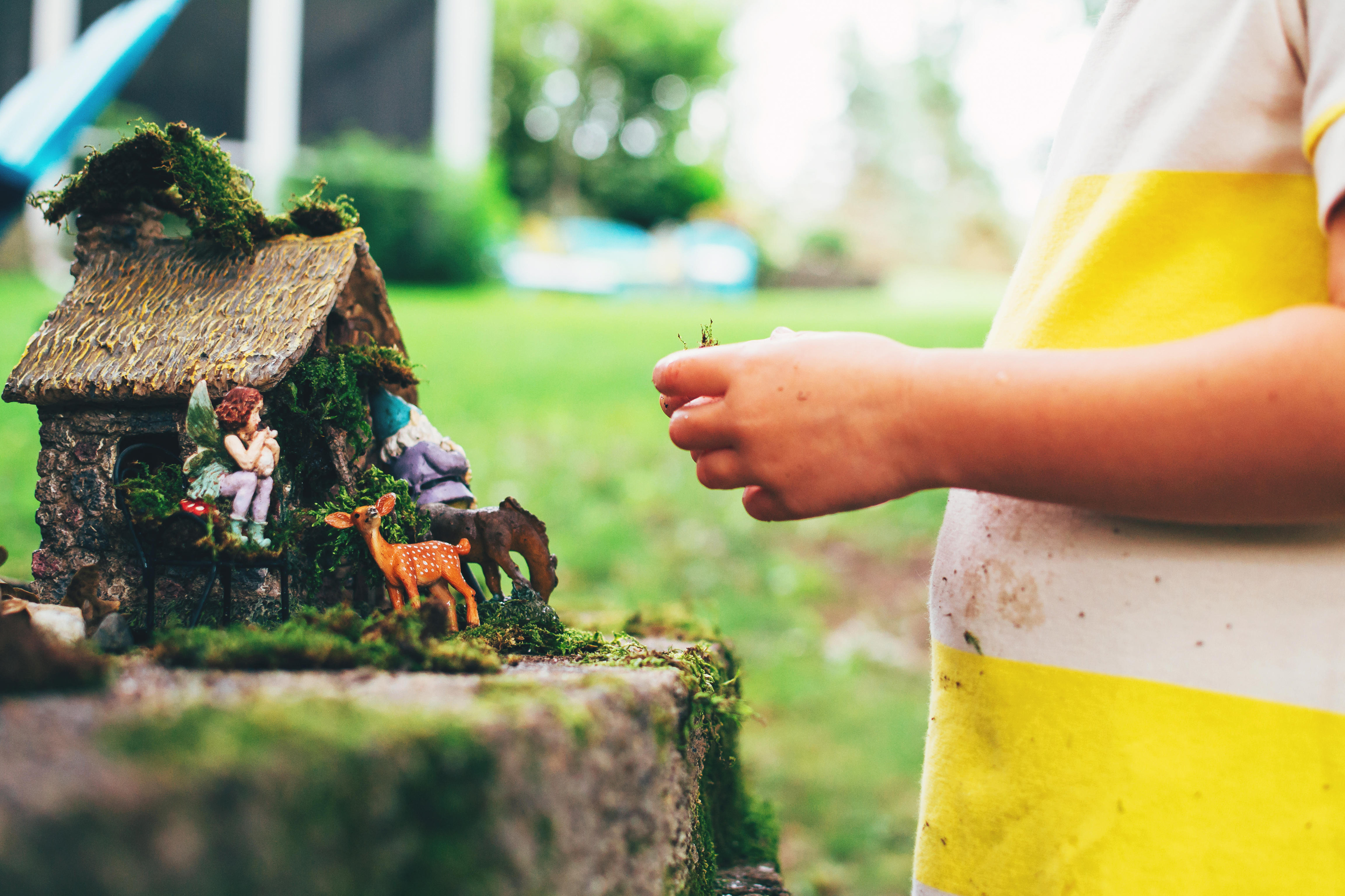Girl playing with fairy garden toys (Alamy/PA)
