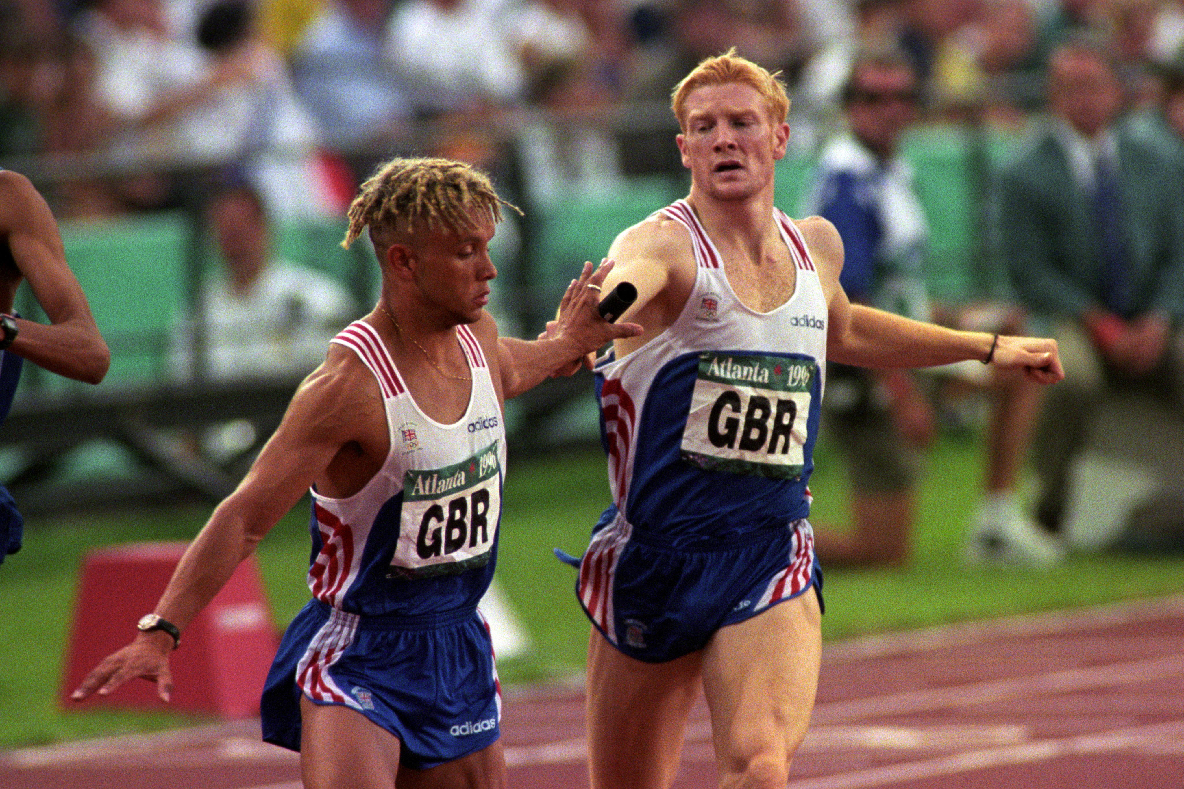 Iwan Thomas passing the baton to James Baulch during the men's 4 x 400 relay semi finals at the Atlanta Olympics