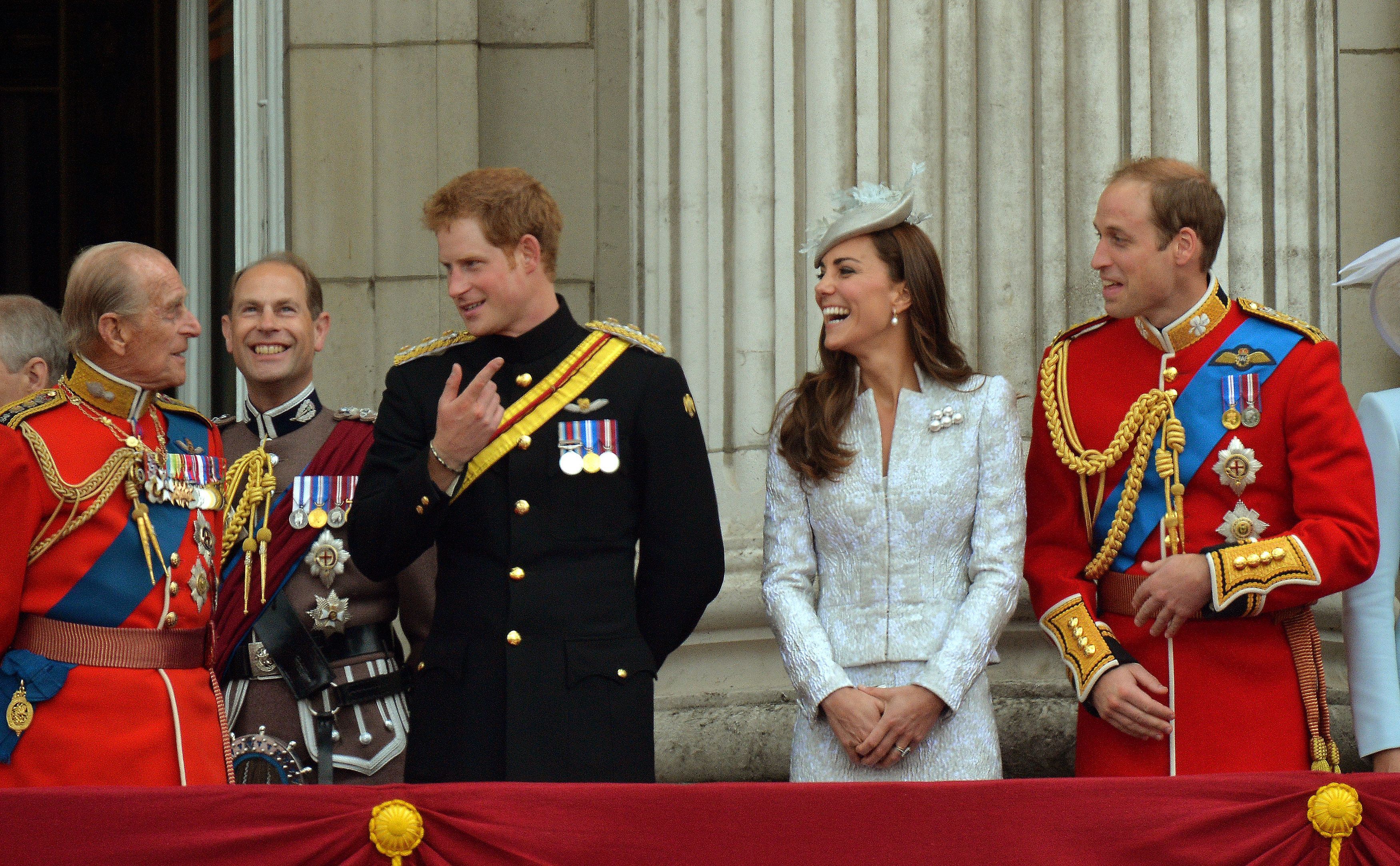 The Duke of Edinburgh, Prince Harry, the Duchess of Cambridge and the Duke of Cambridge (left to right), share a joke on the balcony at Buckingham Palace in 2014