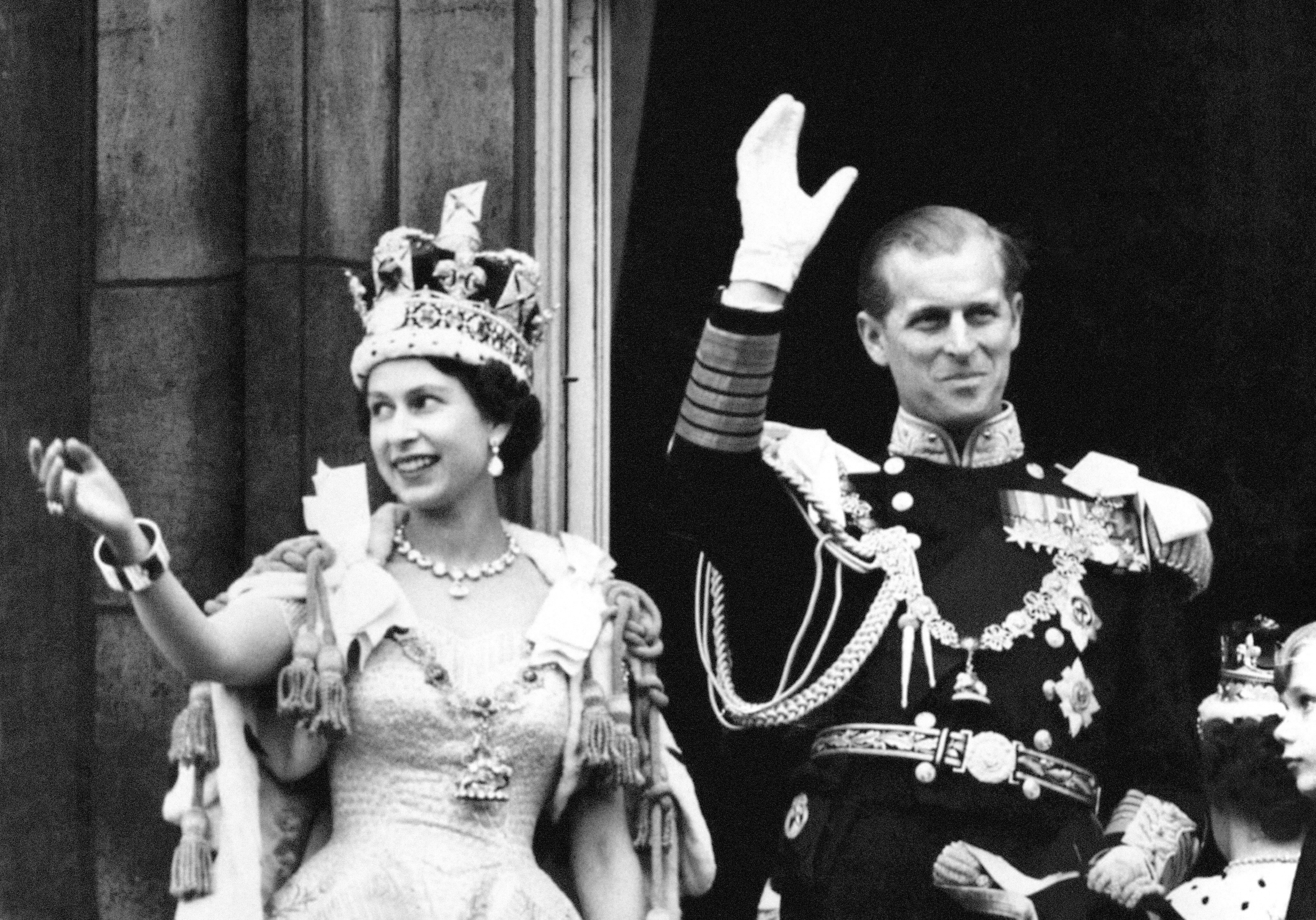 Queen Elizabeth II and the Duke of Edinburgh waving from the balcony after Her Majesty's Coronation
