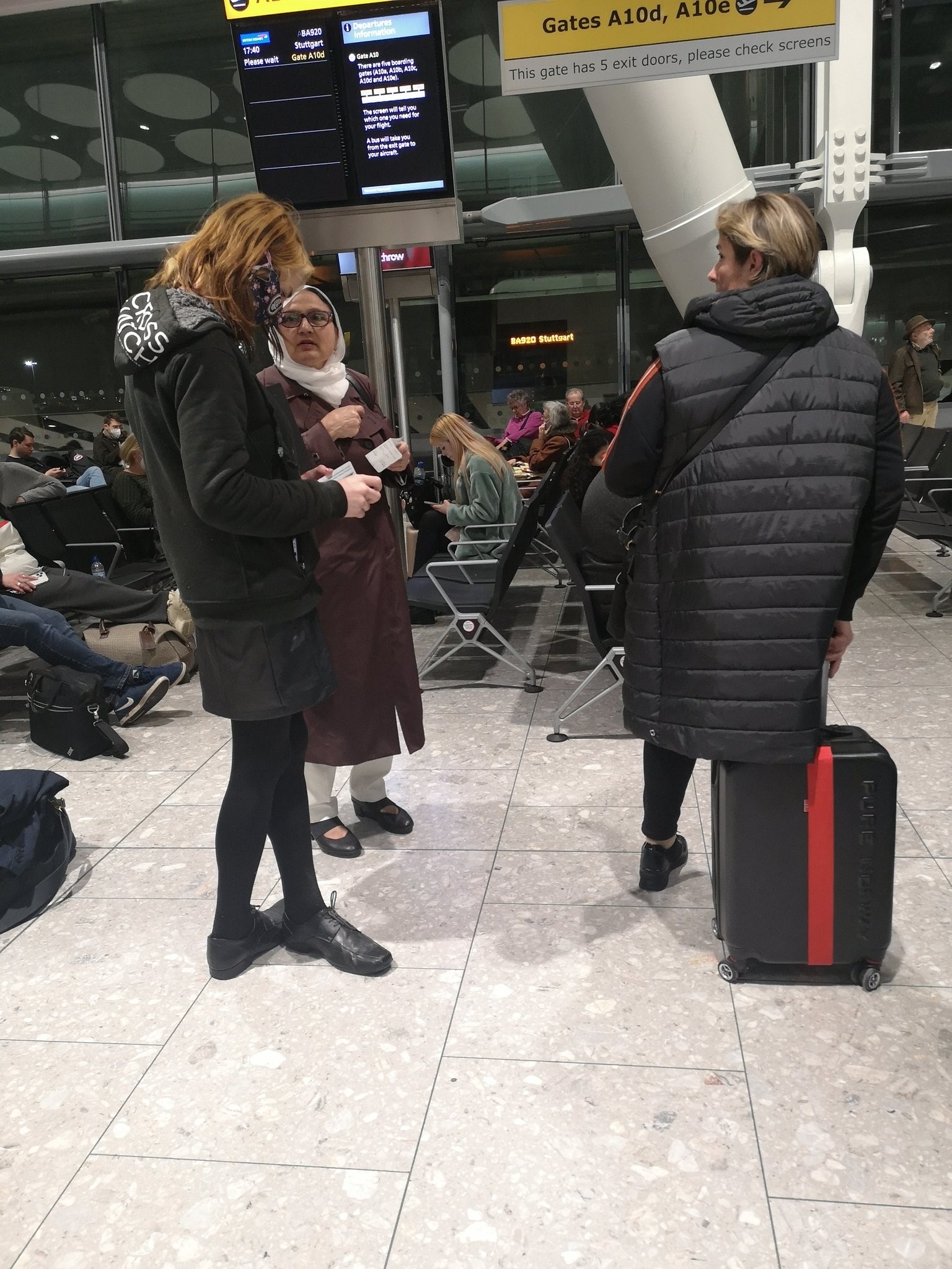 Passengers at Heathrow Airport stand around after flights were delayed on Wednesday.