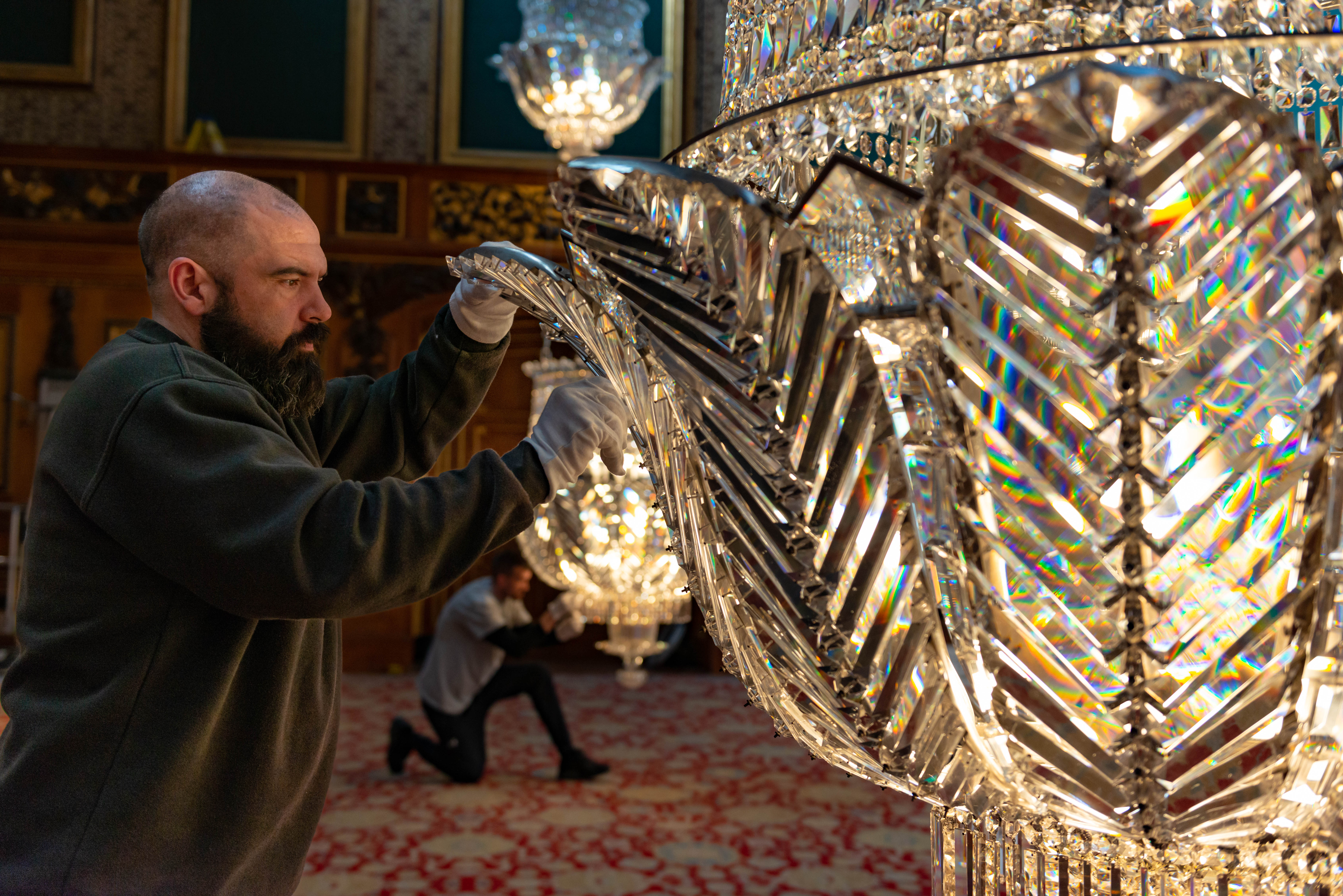 The chandeliers being cleaned in the Waterloo Chamber 