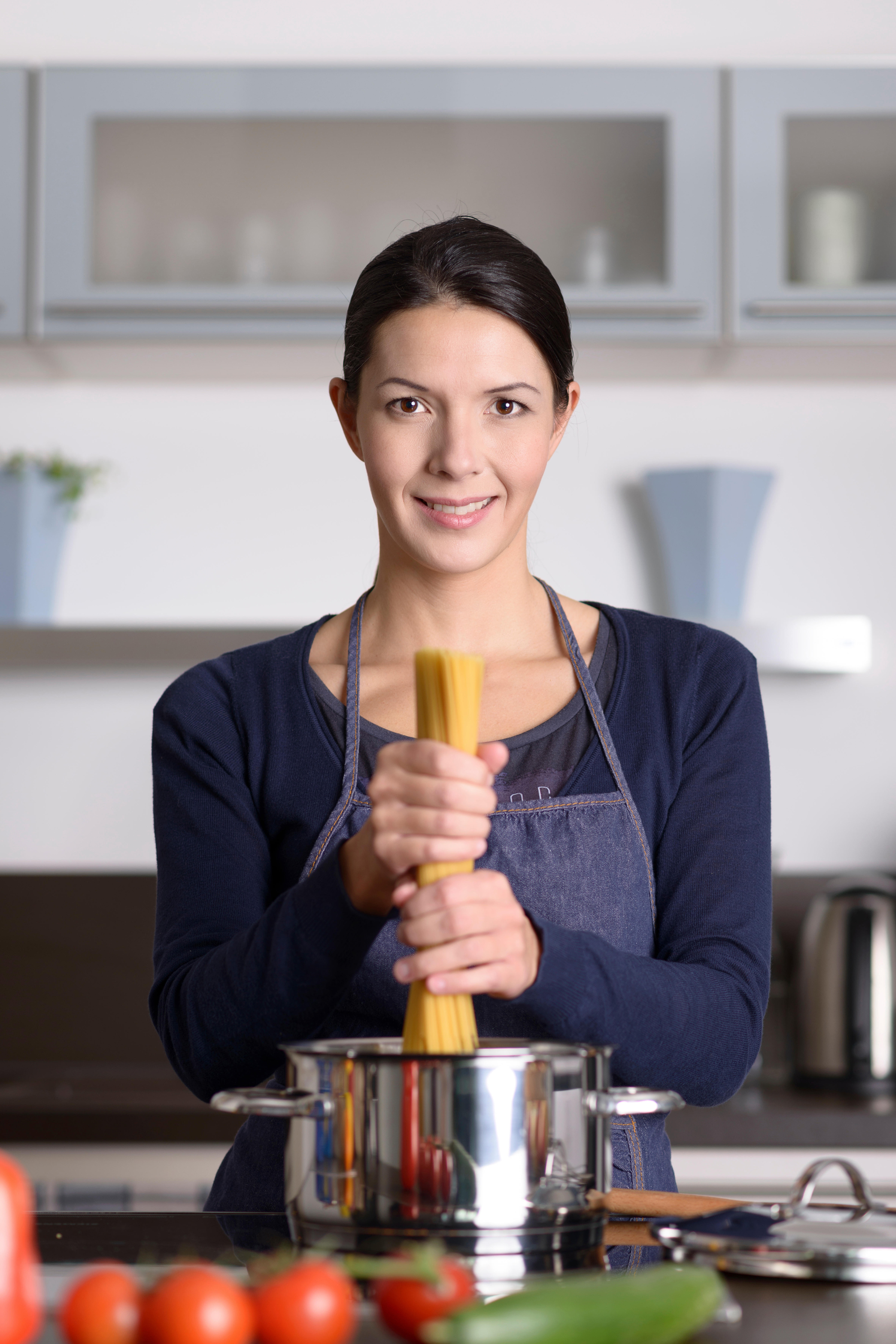 Woman cooking spaghetti