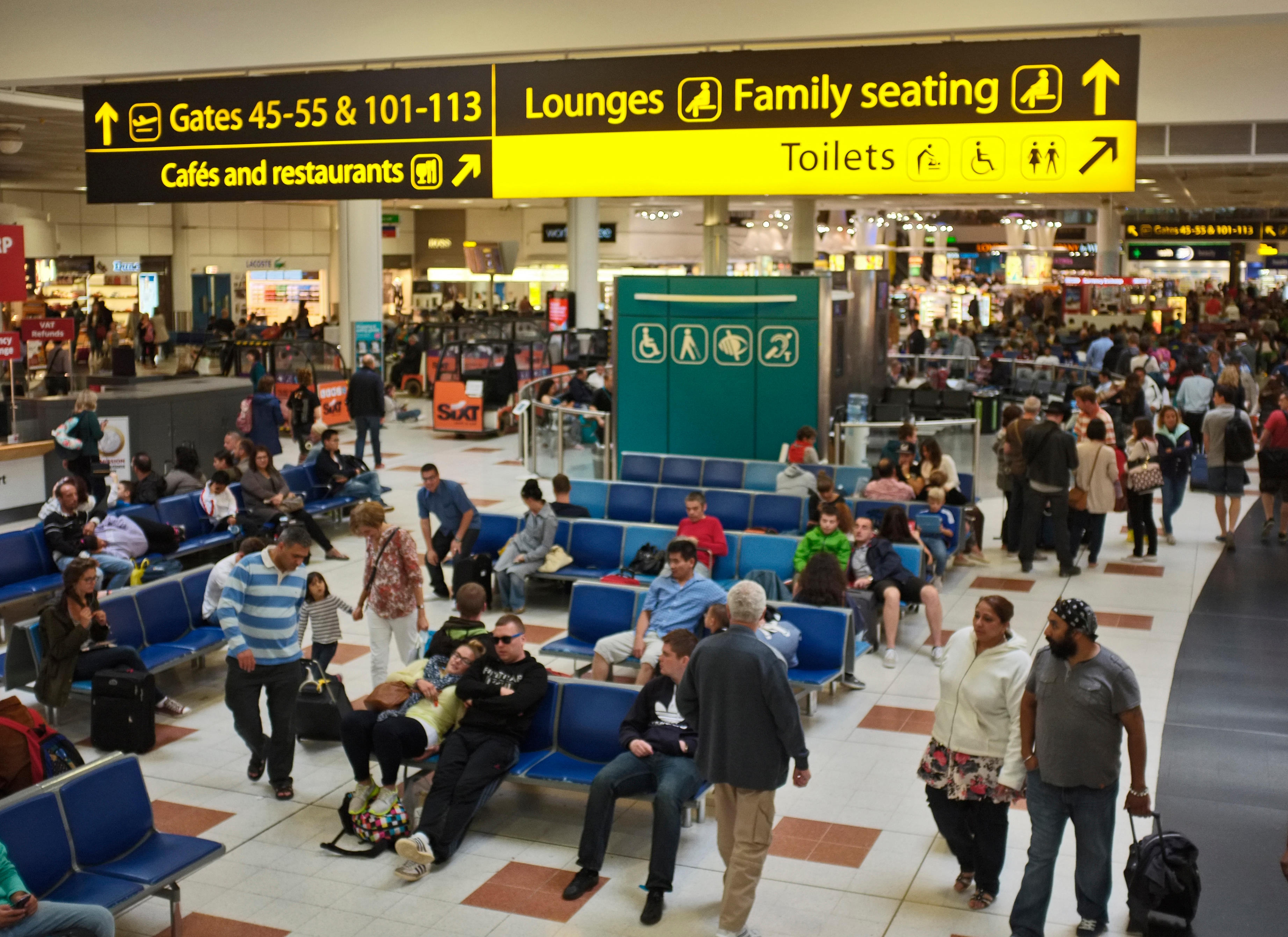 A busy departure lounge with travellers at Gatwick airport (Alamy/PA)
