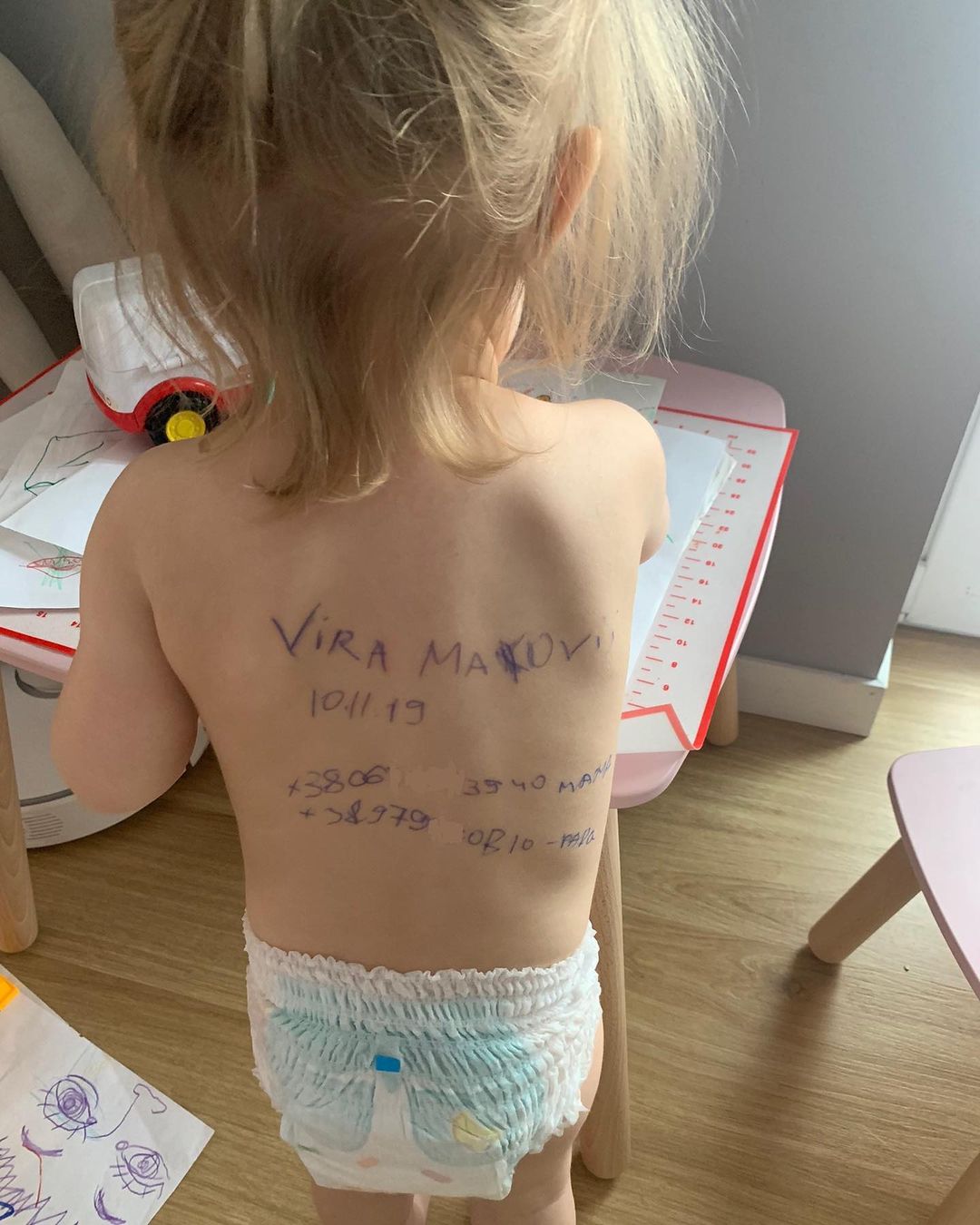 Vira Makoviy with her name and family contact details on her back