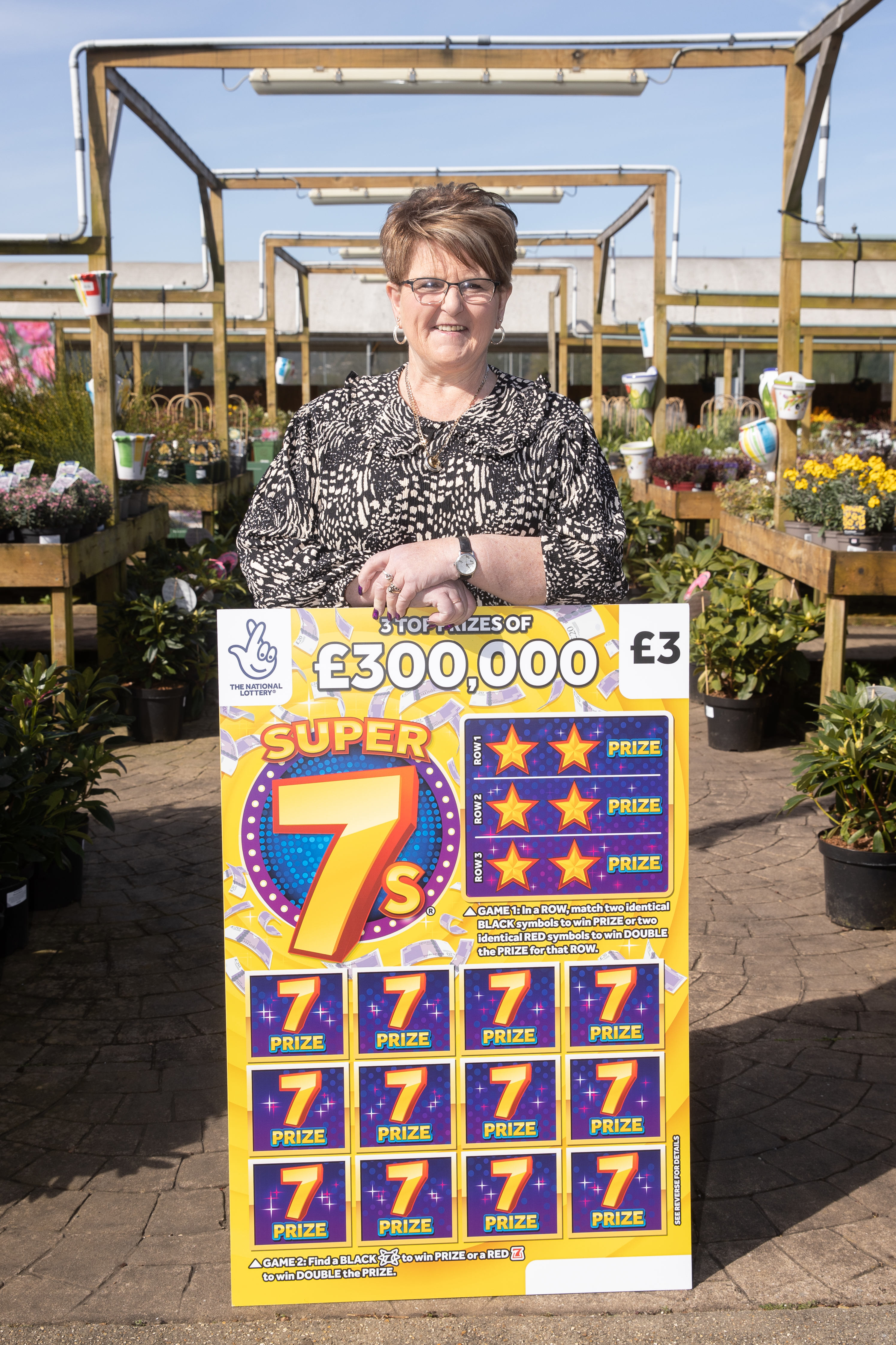 Caroline Walsh, 58, celebrates winning £300,000 on the National Lottery Scratchcard